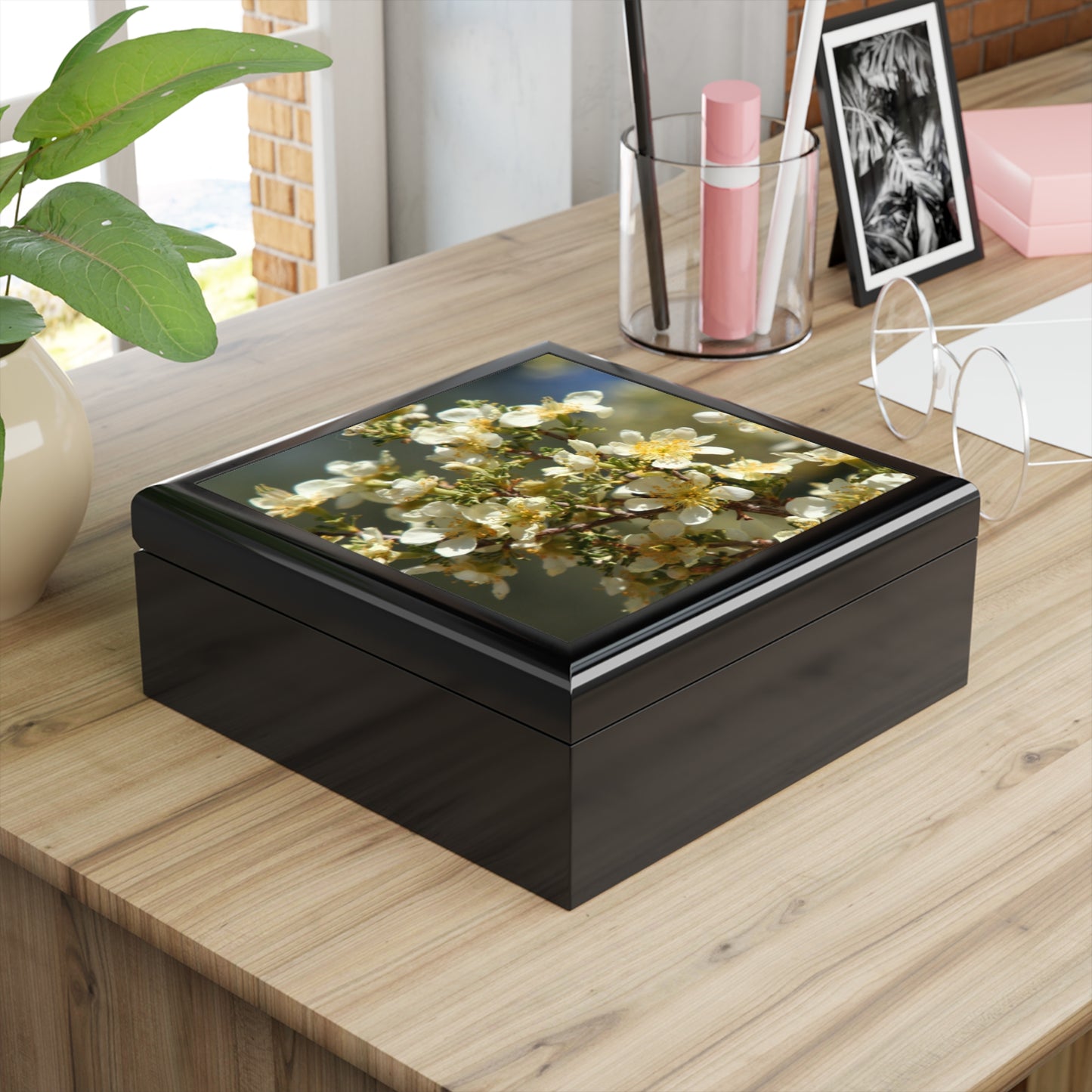 Decorative box with floral design on a wooden surface