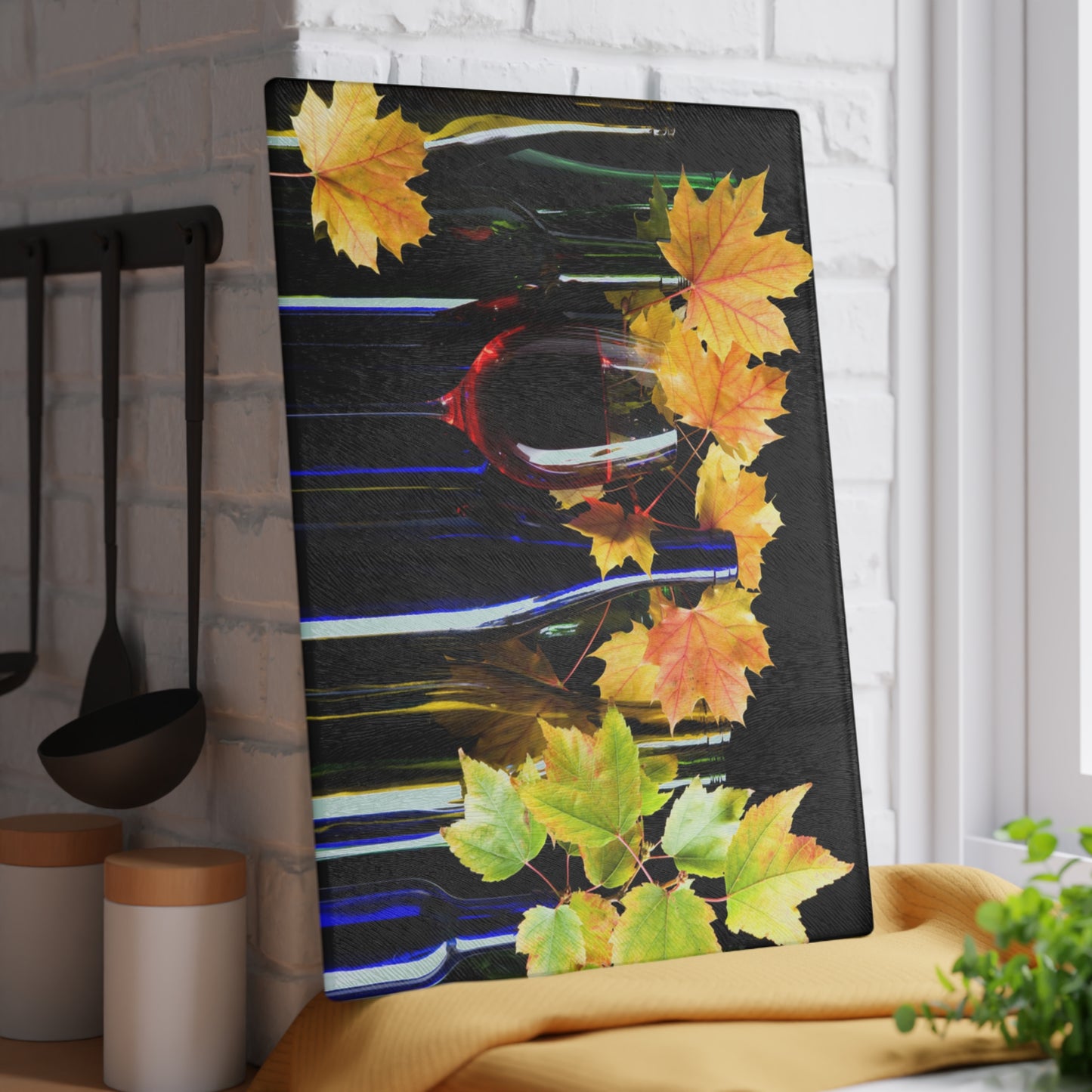 Decorative wall art with autumn leaves in a kitchen setting