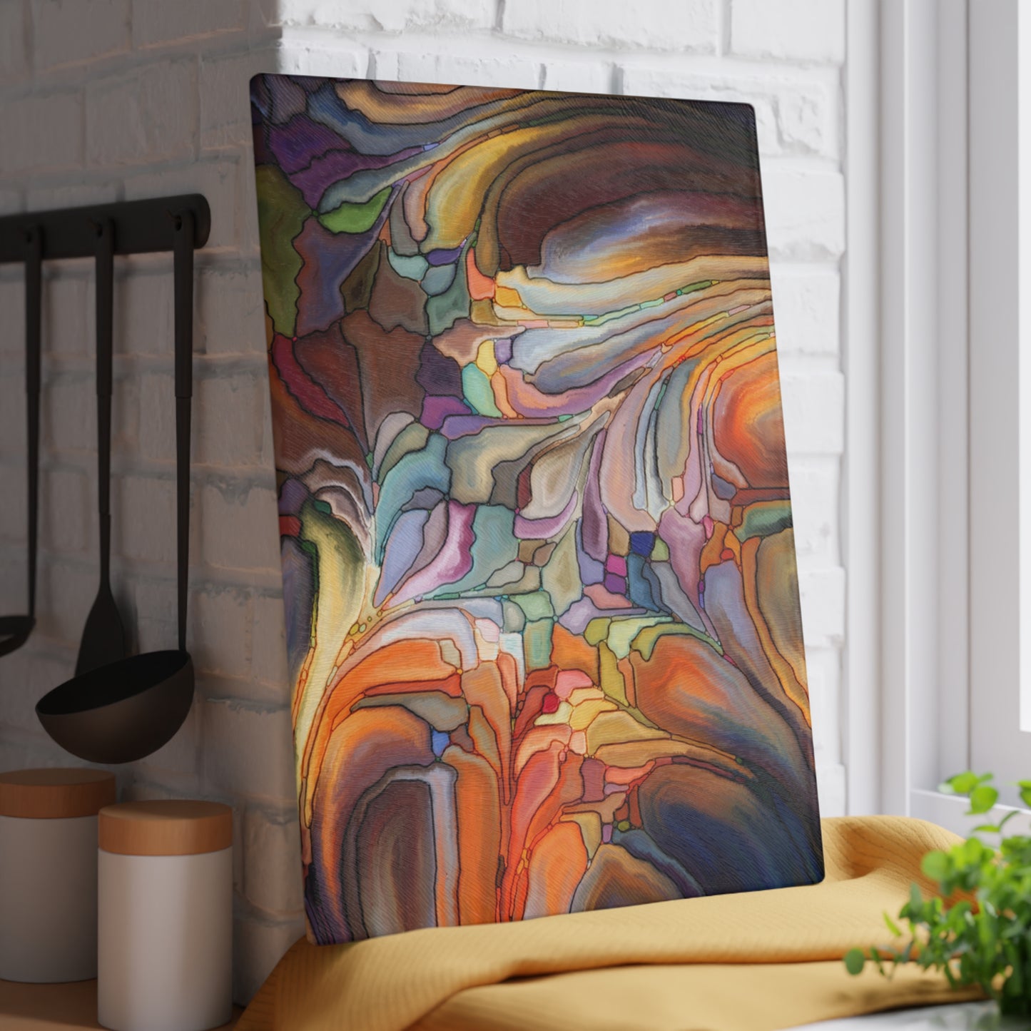 Colorful abstract art panel in a kitchen setting with utensils and decor.