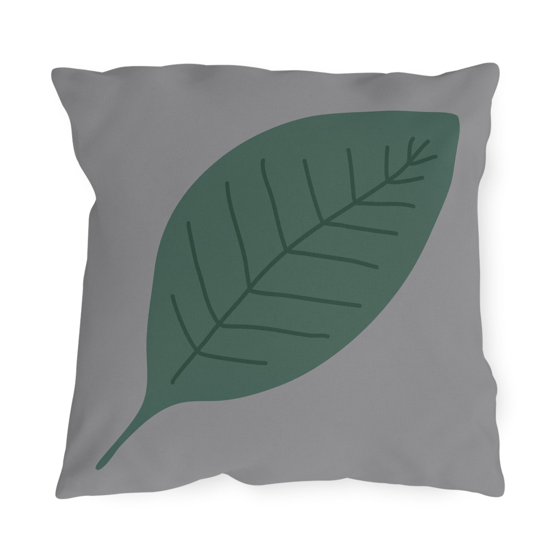 Gray pillow with a green leaf design on a white background