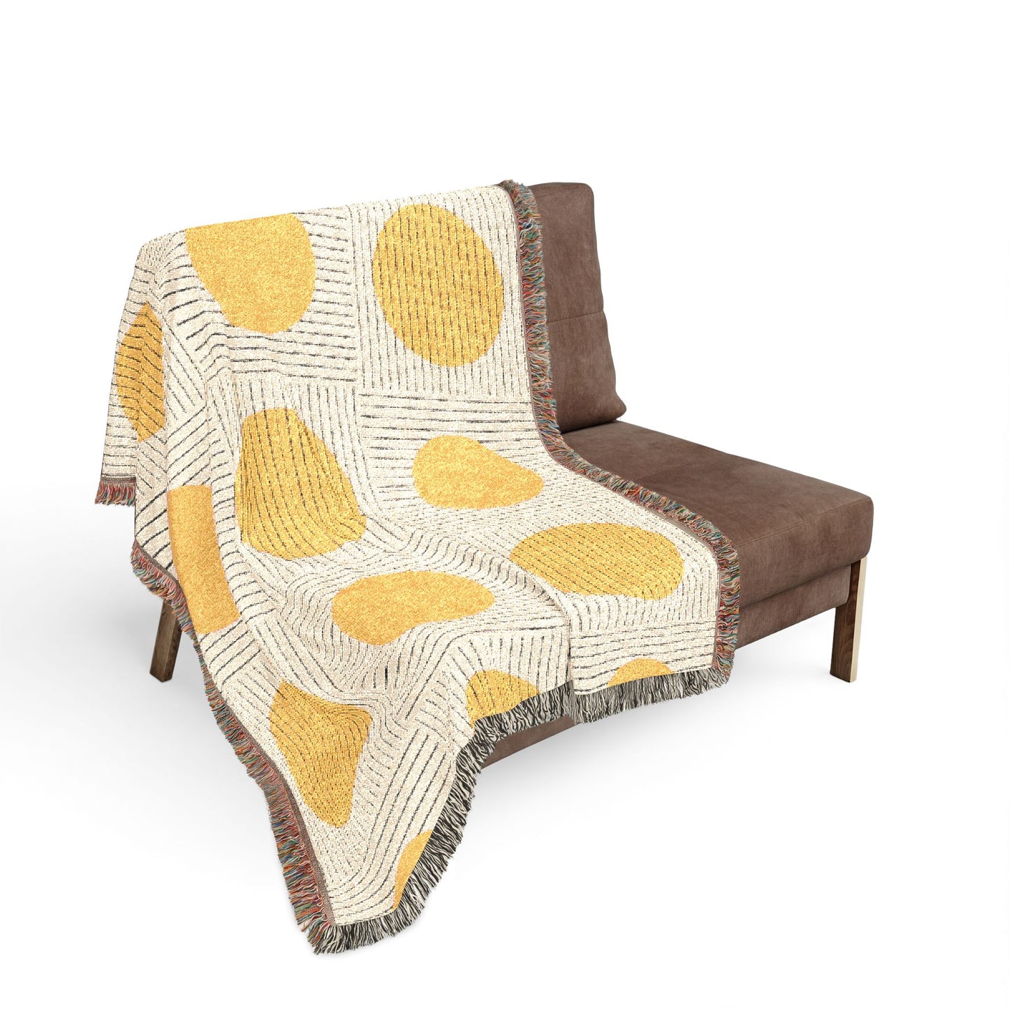 Textured blanket with yellow and brown pattern draped over a brown chair on a white background