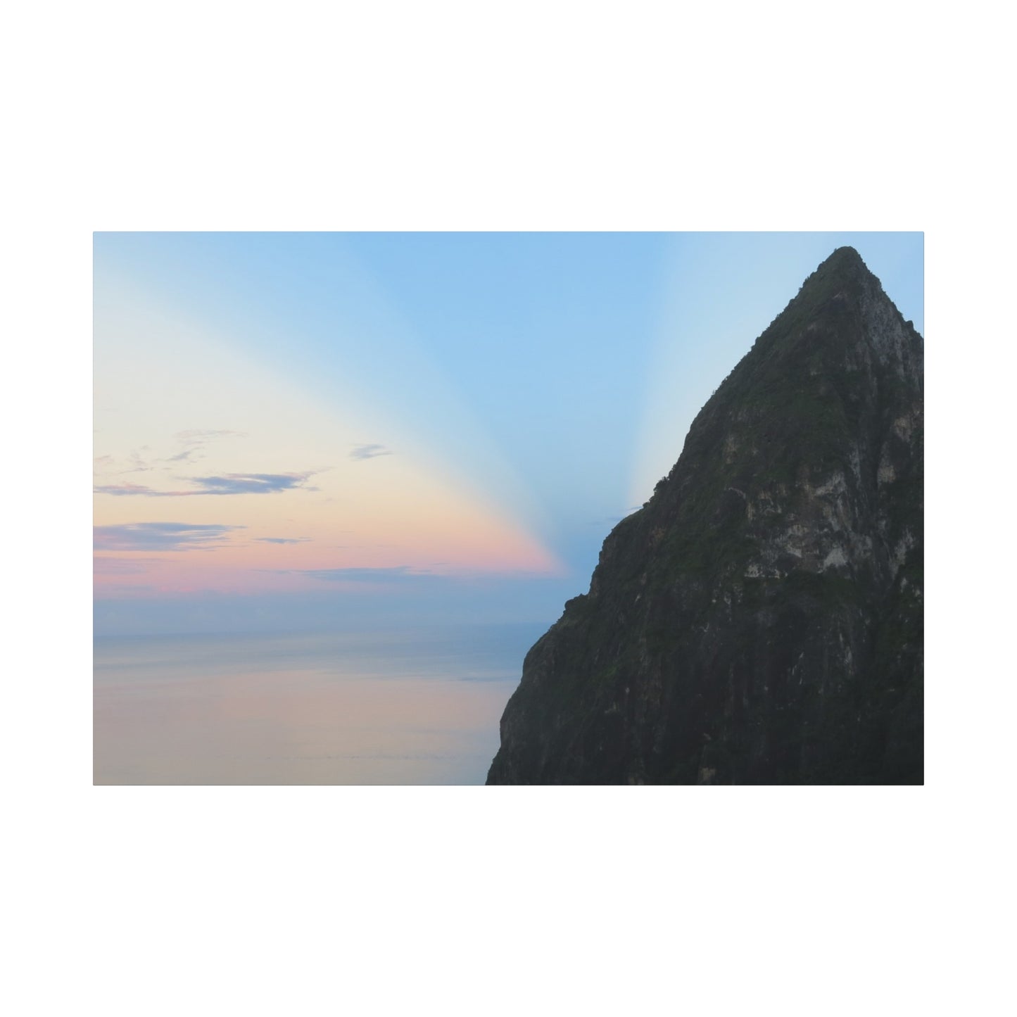 Rocky cliff with a colorful sky in the background