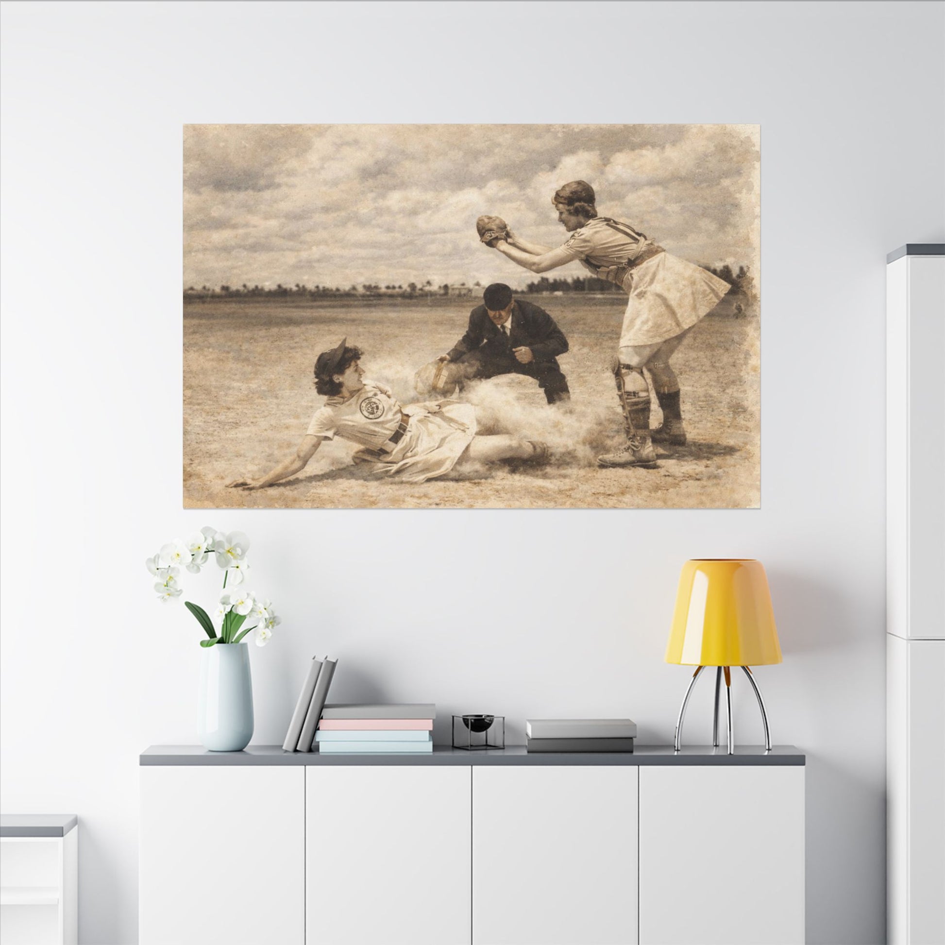 Vintage-style baseball scene on a wall above a modern kitchen counter with a lamp and decor items.
