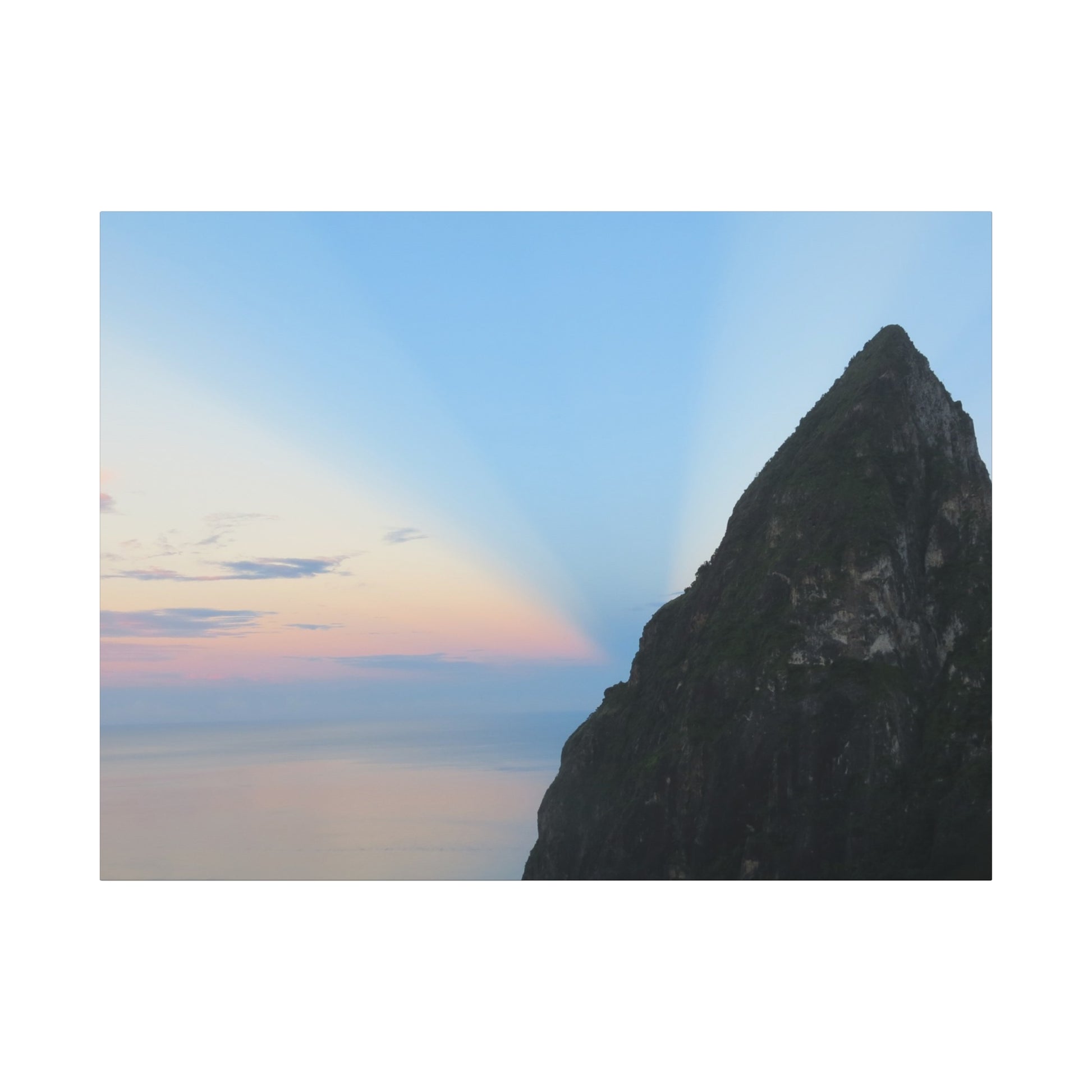 Mountain peak with a rainbow in the sky