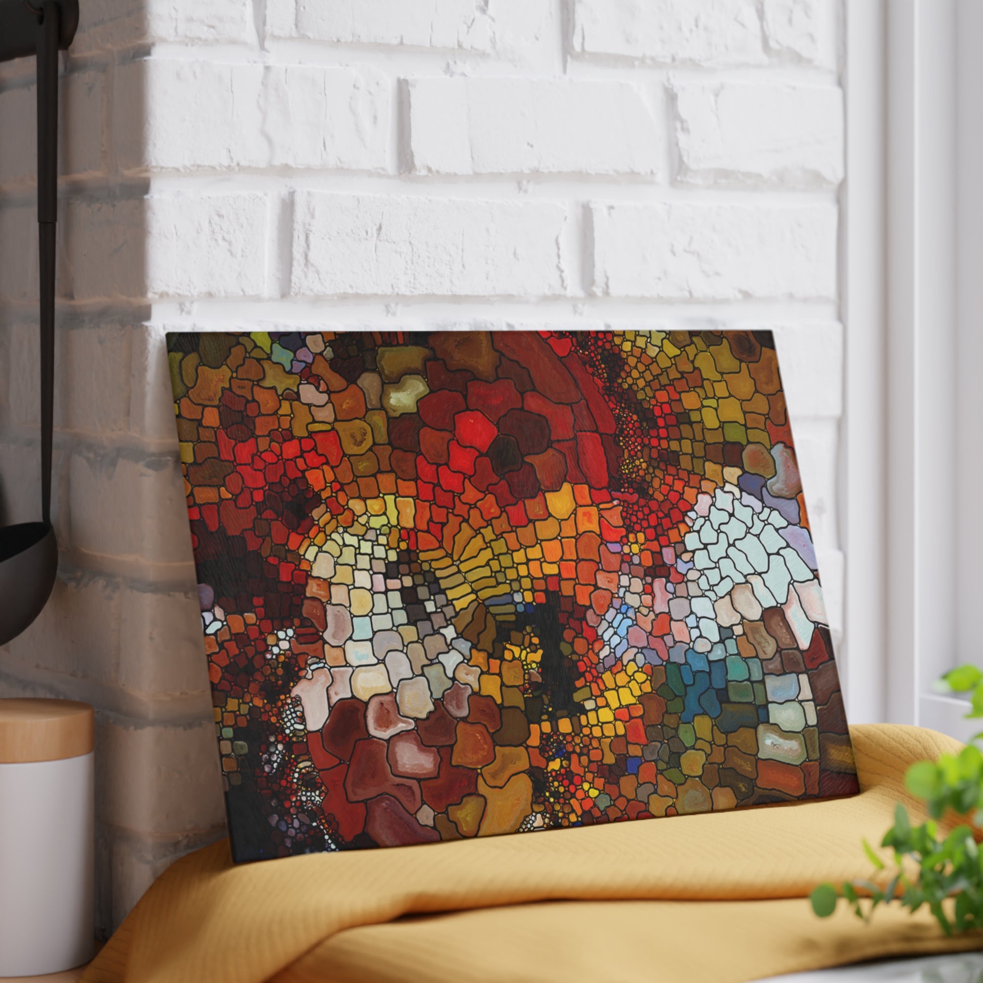Colorful mosaic art piece on a white brick wall