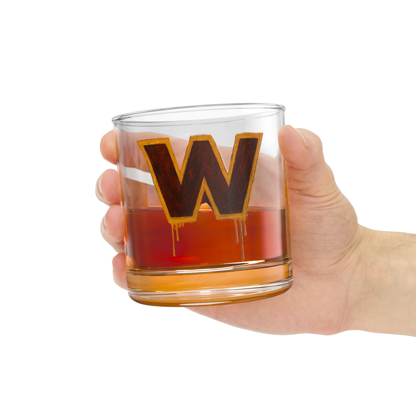 Hand holding a glass with a letter 'W' design filled with a red liquid on a white background