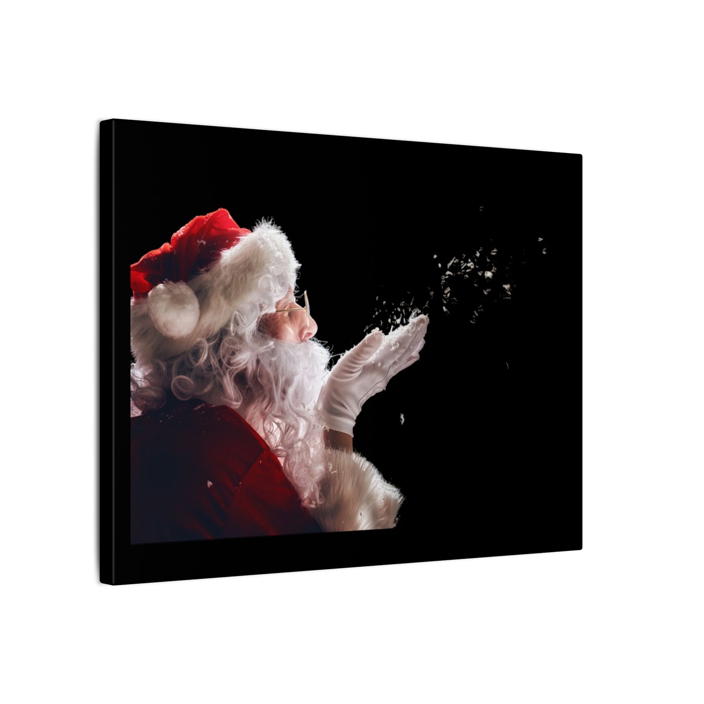 Canvas print of Santa Claus blowing snowflakes against a black background