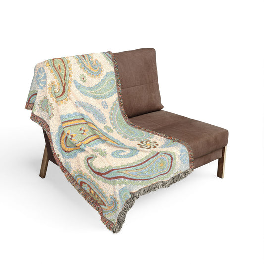Patterned blanket draped over a brown chair on a white background