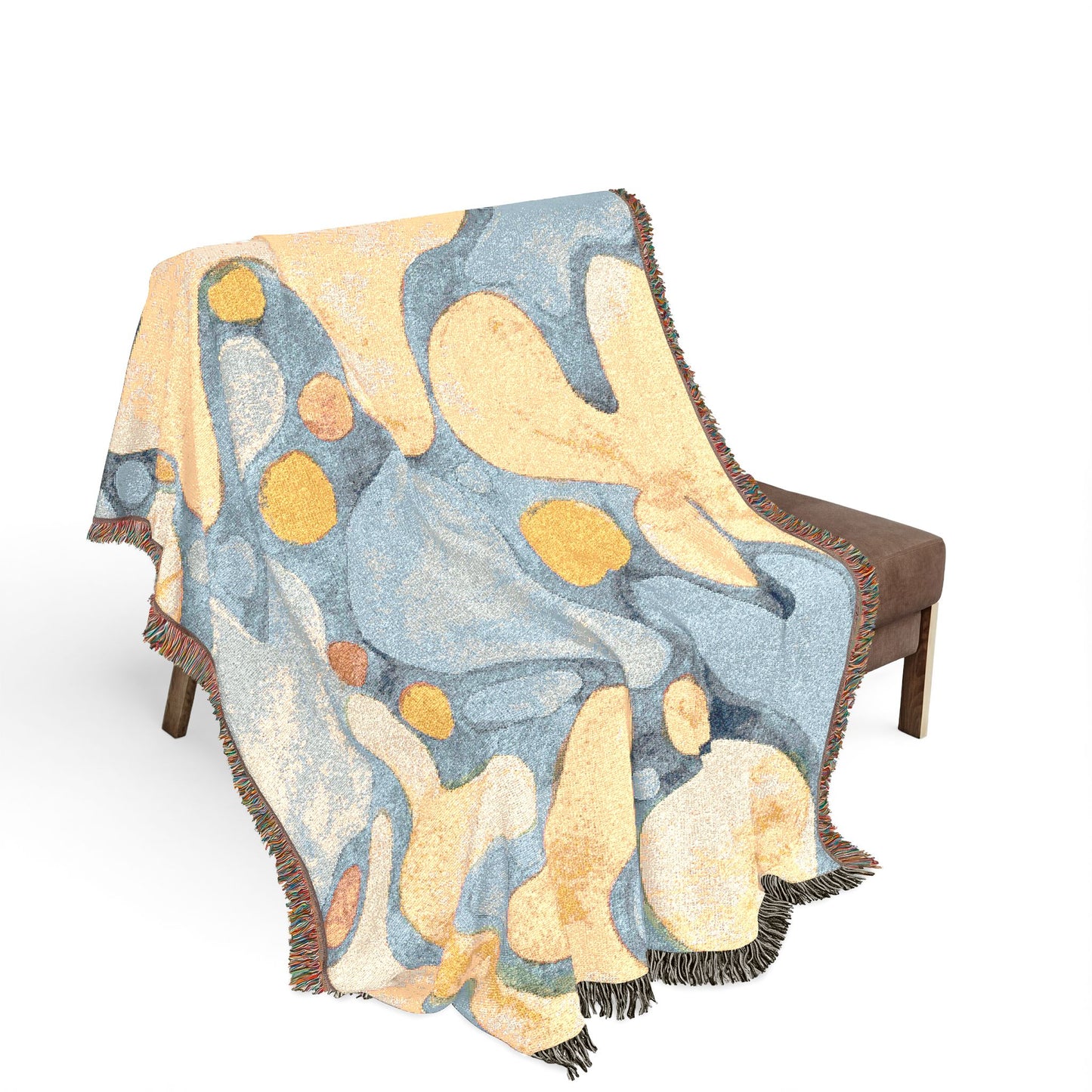 Decorative blanket with abstract design on a chair against a white background