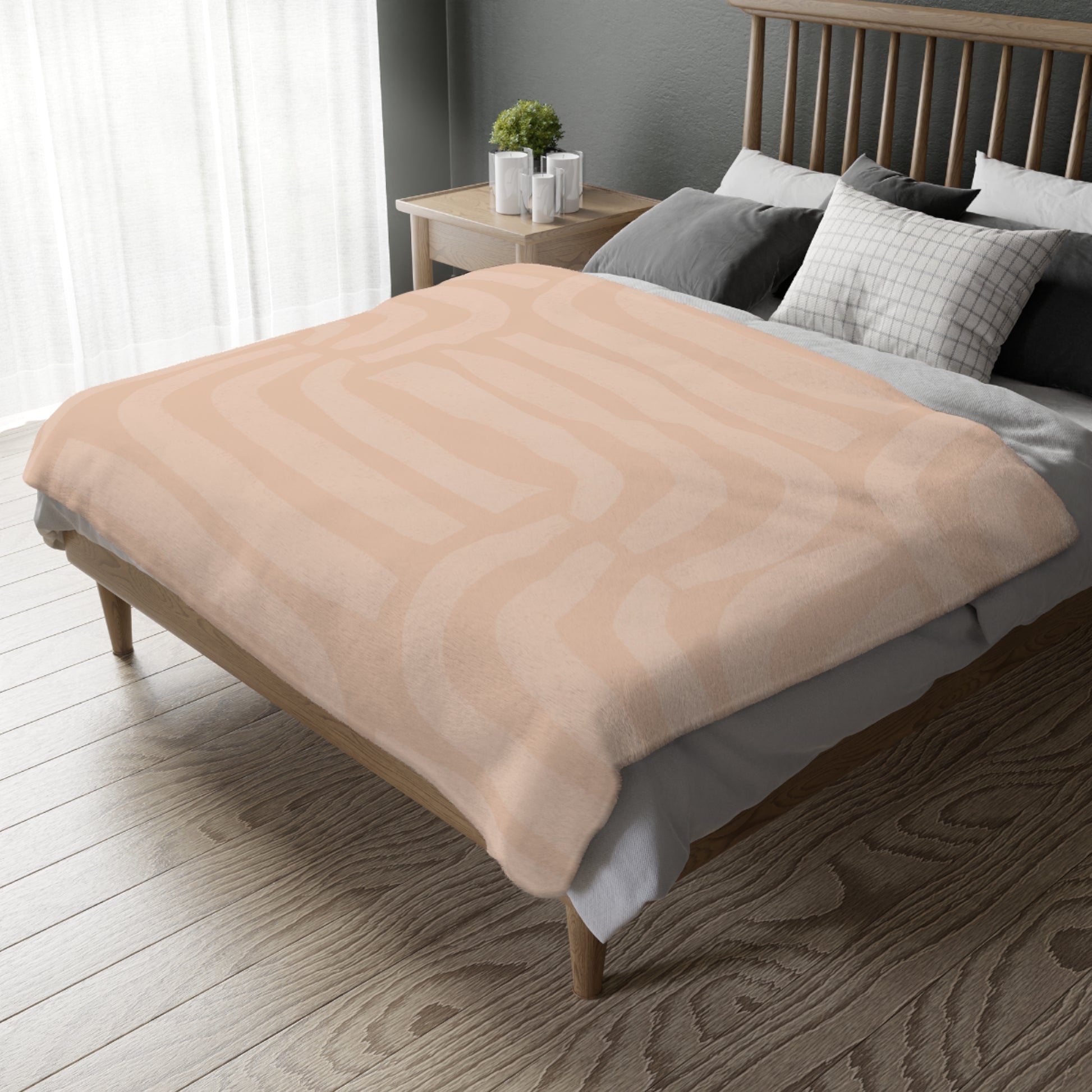 Beige blanket draped over a bed in a bedroom setting