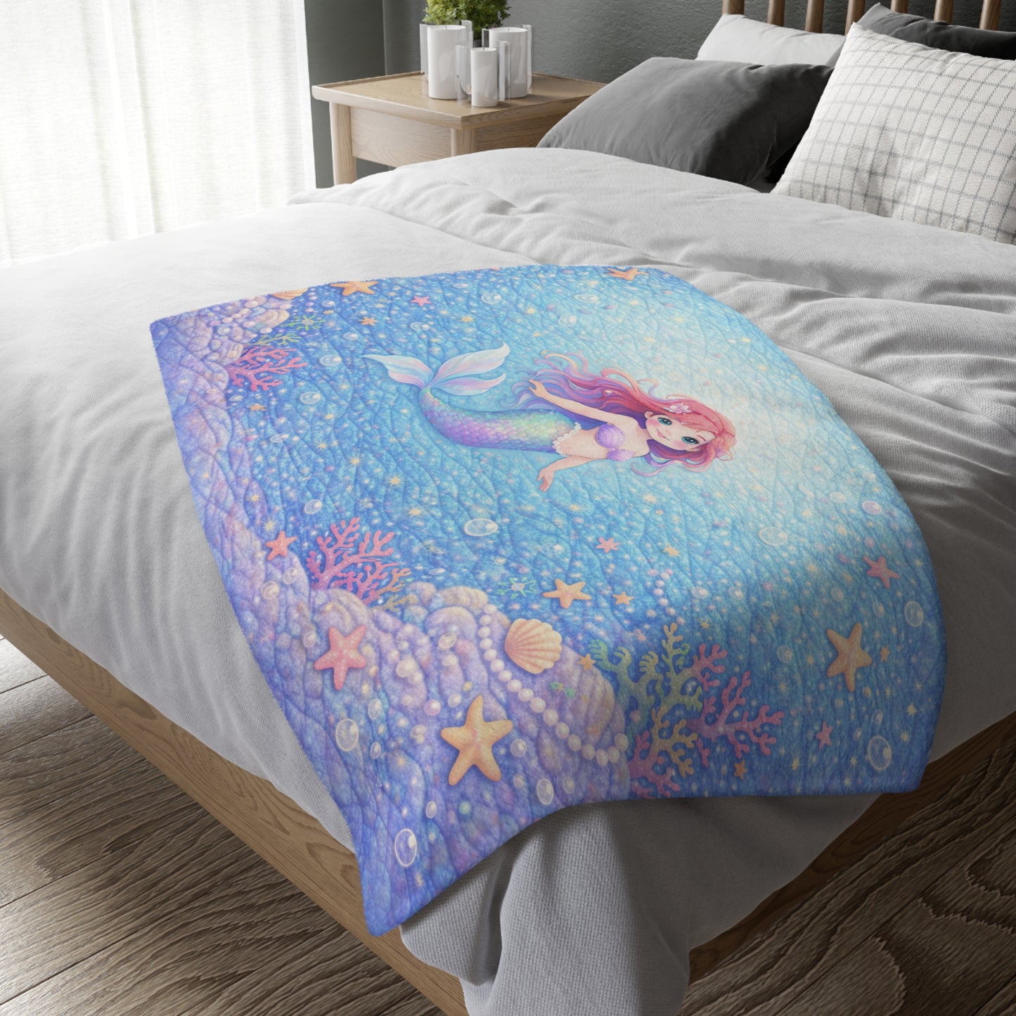 Colorful mermaid-themed blanket on a bed in a bedroom setting