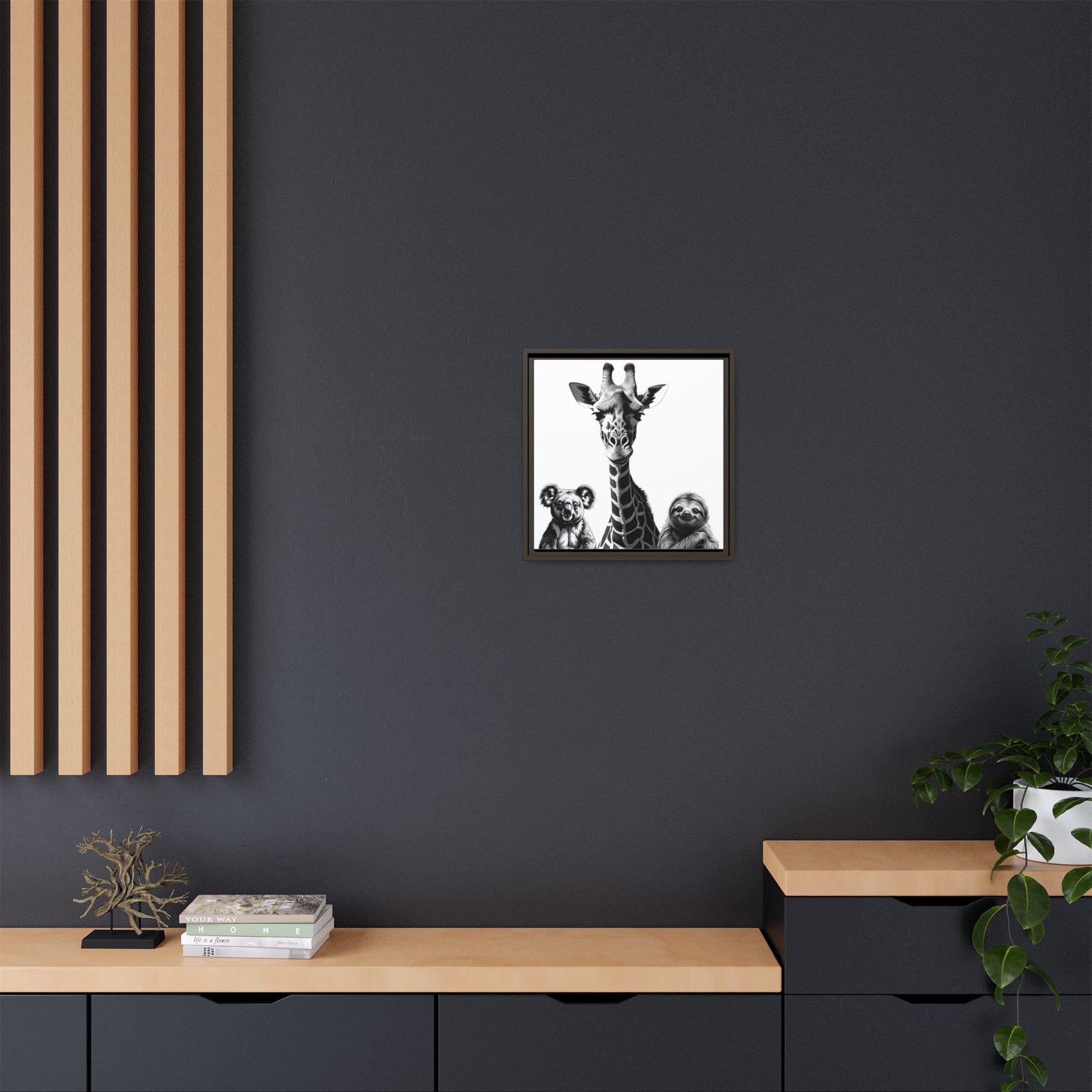 Framed artwork of a giraffe and two bears on a dark wall with wooden furniture and decor.