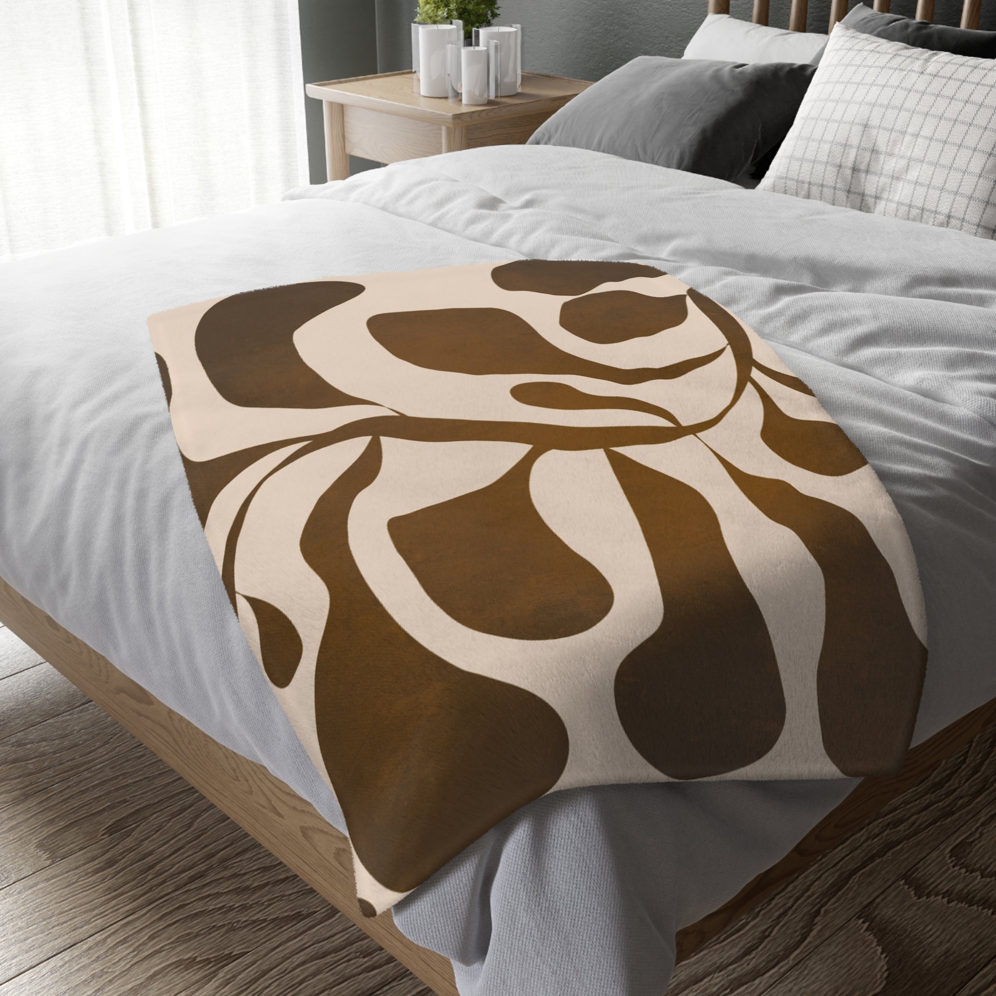 Brown and beige patterned blanket on a bed in a bedroom setting