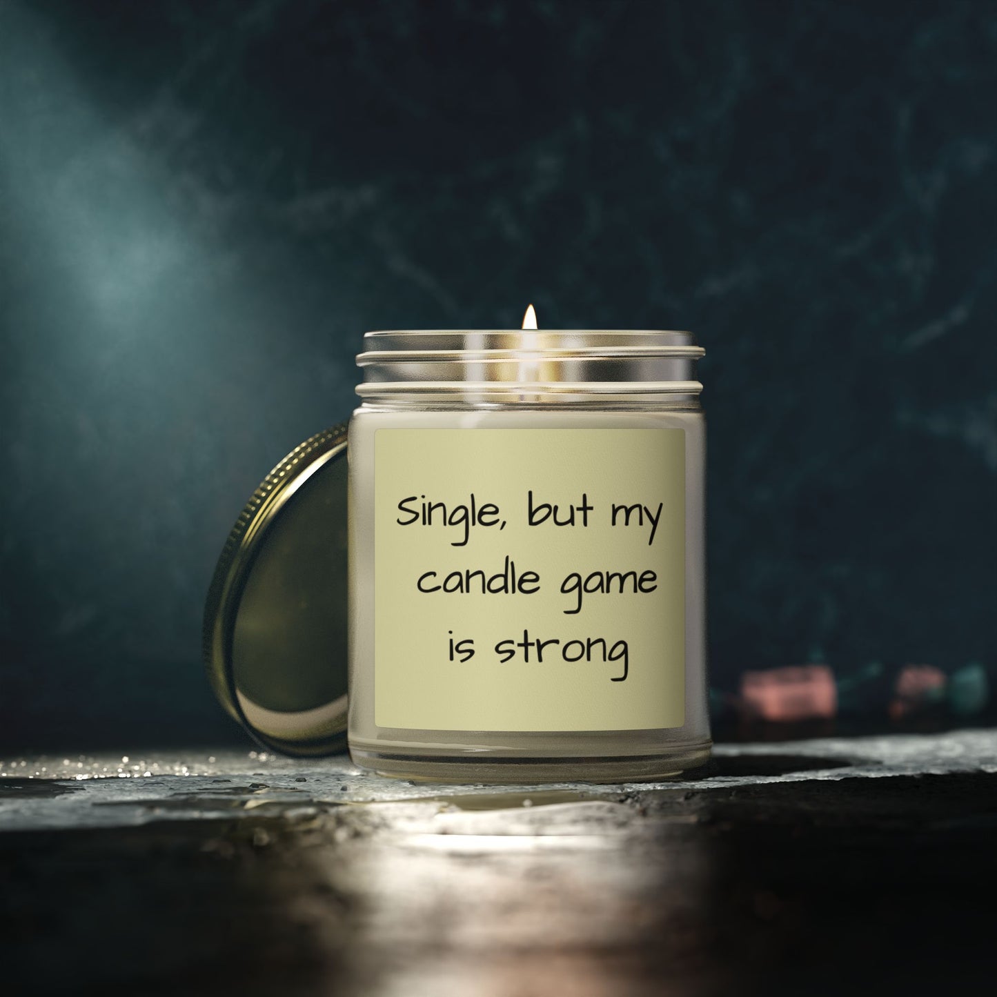 Candle with a humorous label on a dark background