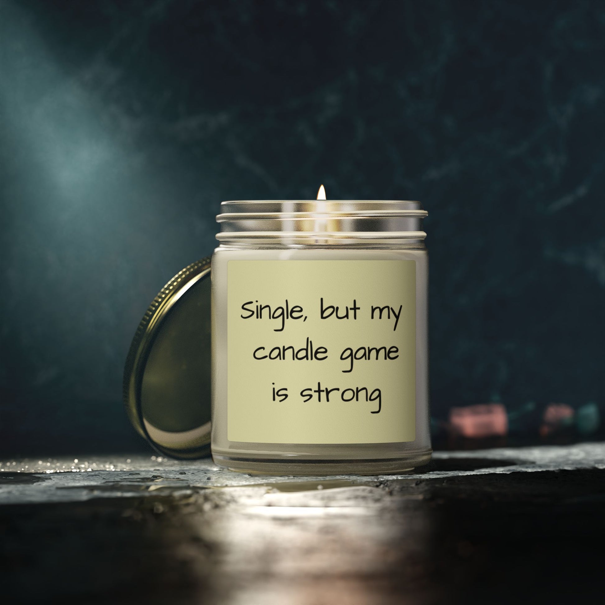 Candle with a humorous label on a dark background