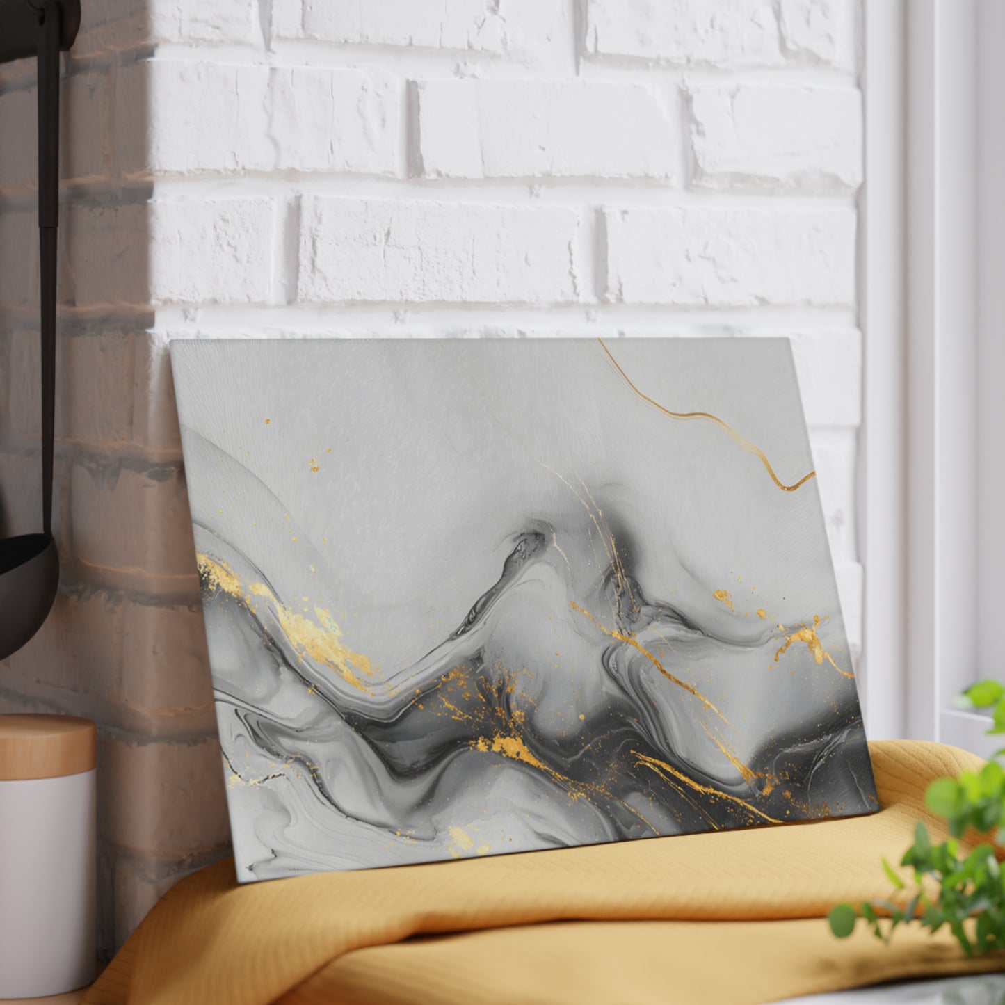 Marble-patterned wall art with gold accents on a white brick wall.