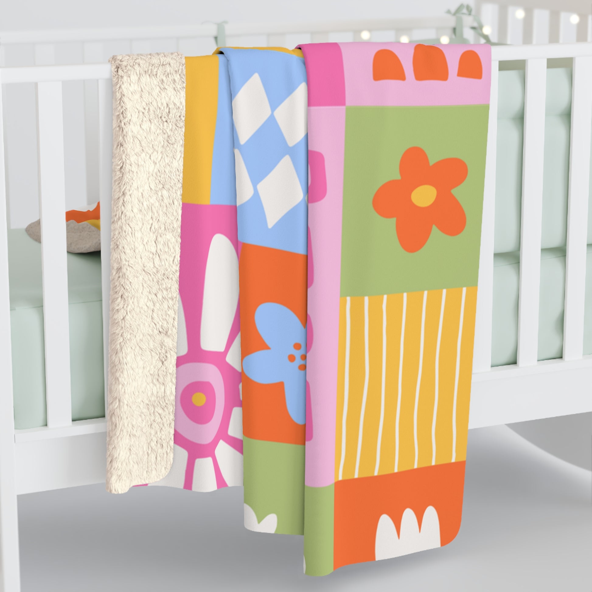 Colorful baby crib sheet with floral patterns on a white crib