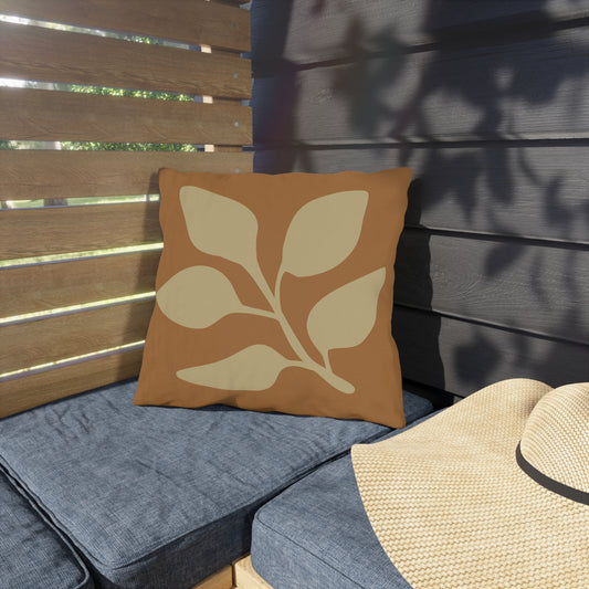Outdoor seating with a decorative pillow and a straw hat on a wooden bench.