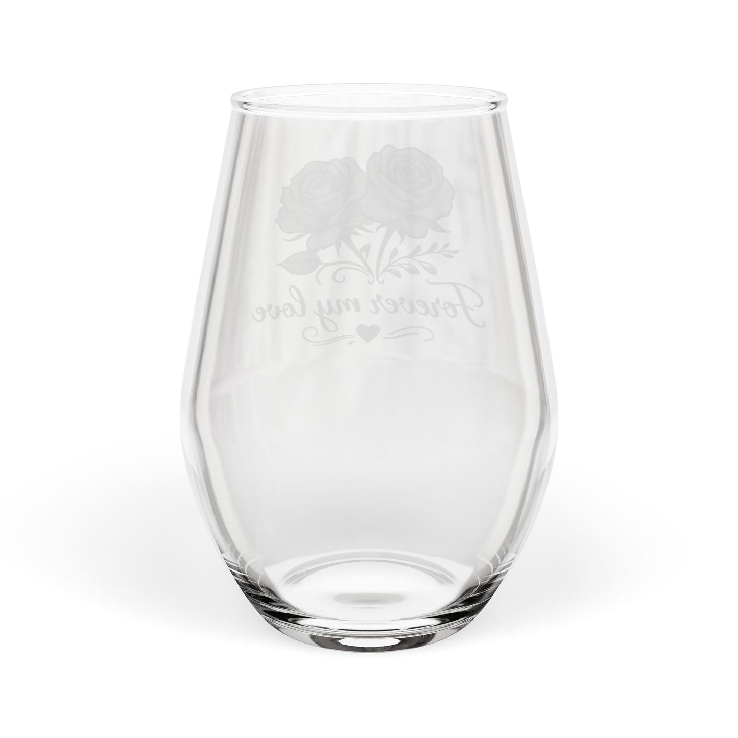 Clear glass wine glass with engraved design on a white background