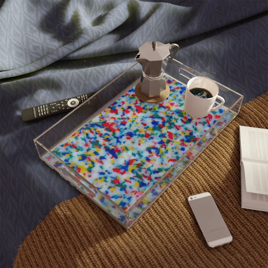 Clear tray with colorful placemat on a bed, featuring a coffee maker and cup.