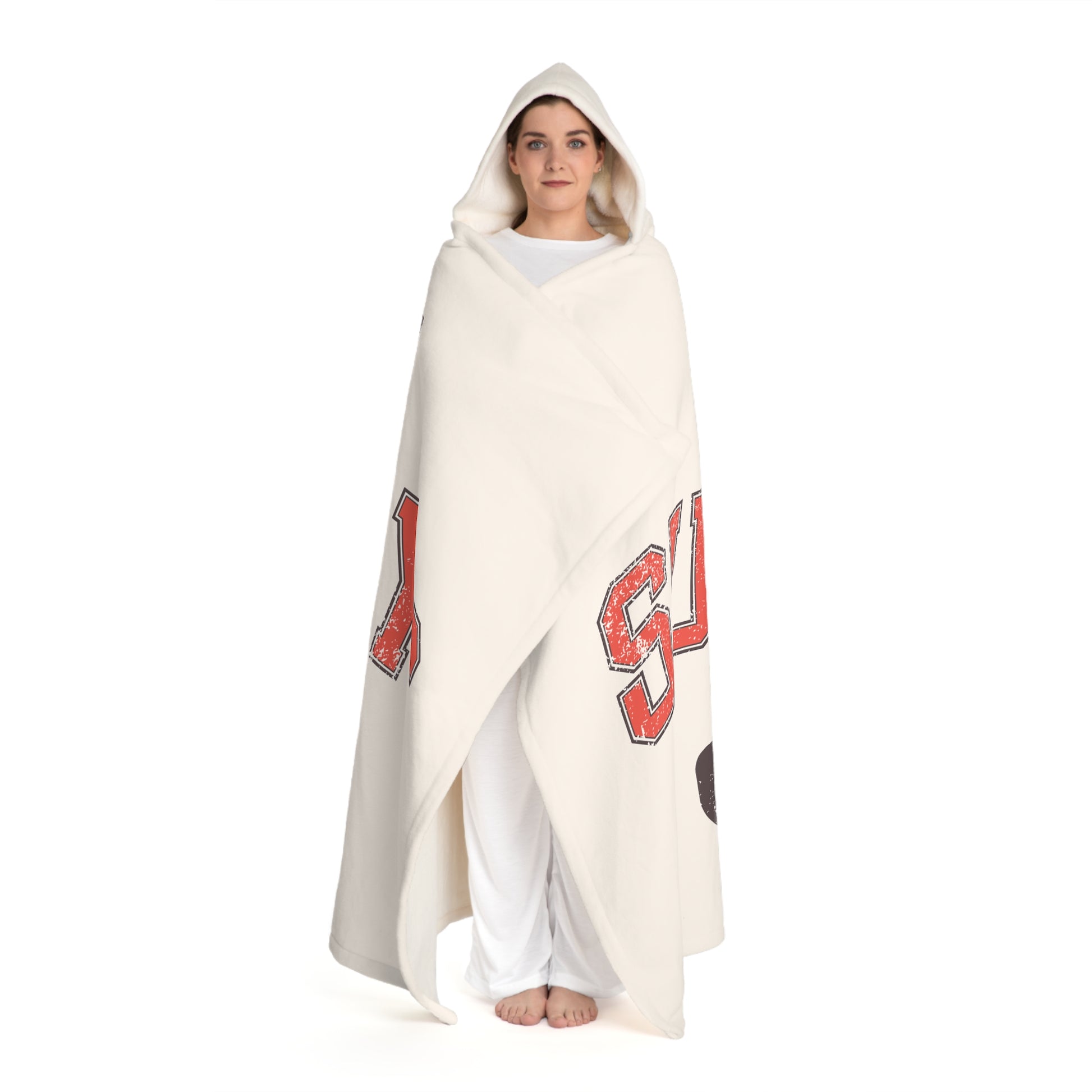 Person wrapped in a white blanket with red patterns on a white background