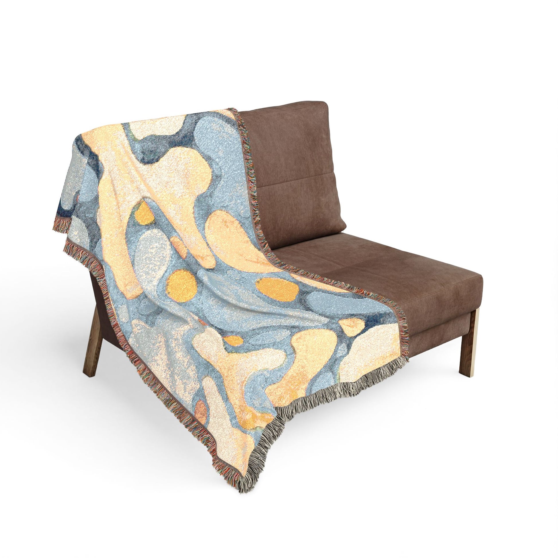 Brown chair with a colorful abstract patterned throw blanket on a white background