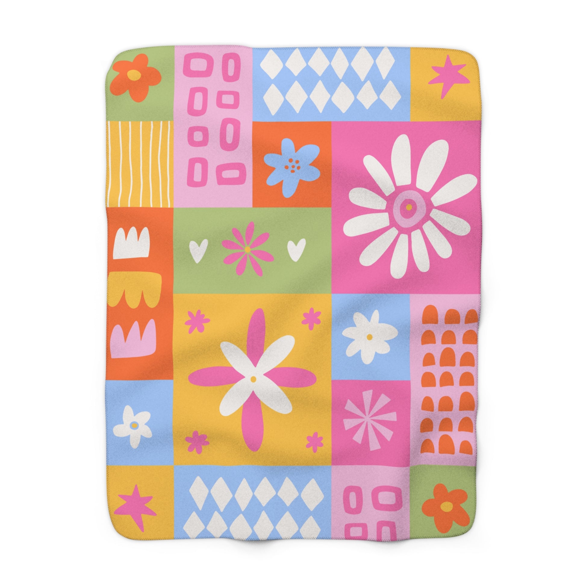 Colorful quilt with geometric and floral patterns on a white background