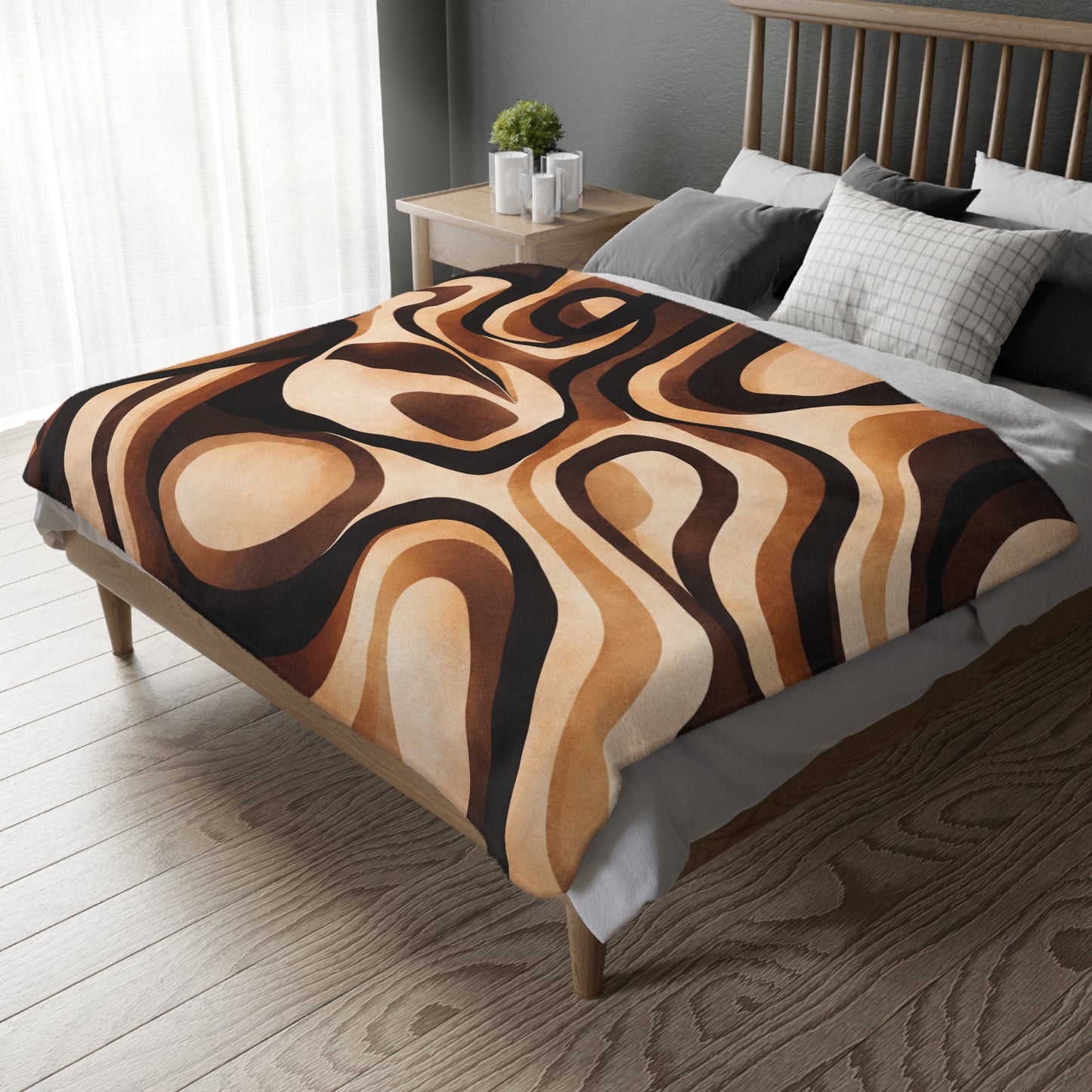 Bed with a patterned brown and beige blanket in a bedroom setting.