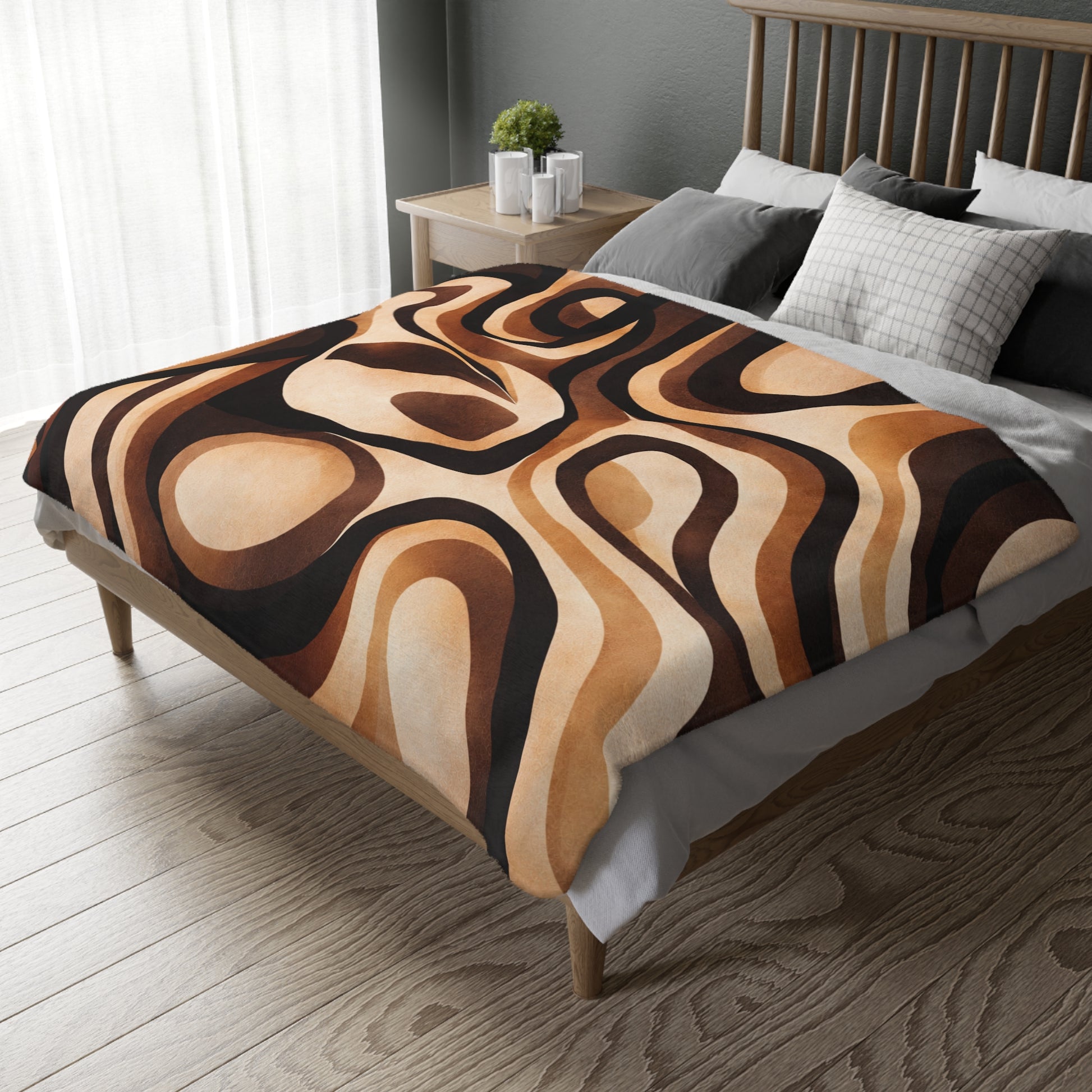 Bed with a patterned brown and beige blanket in a bedroom setting.