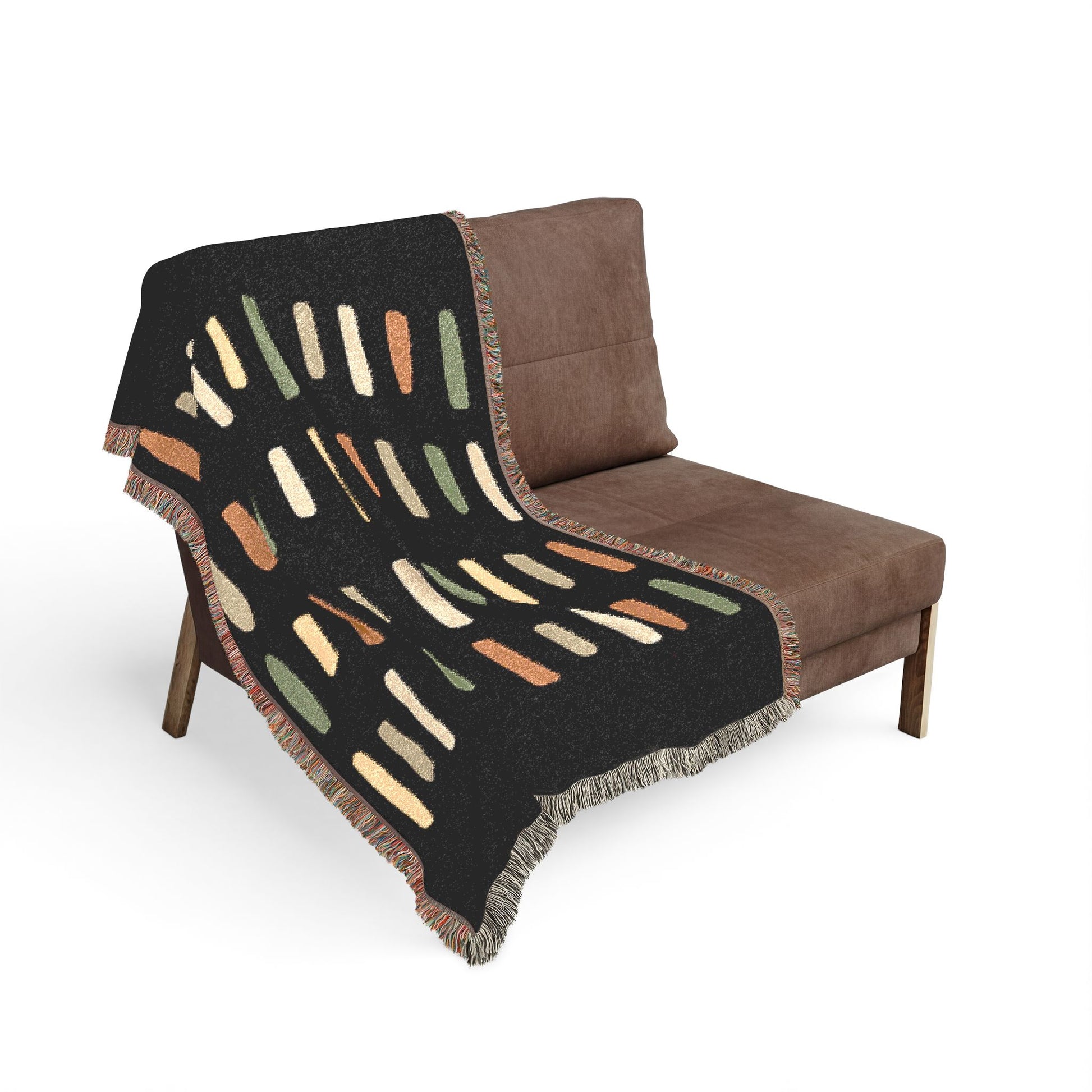 Brown chair with a black patterned throw blanket on a white background