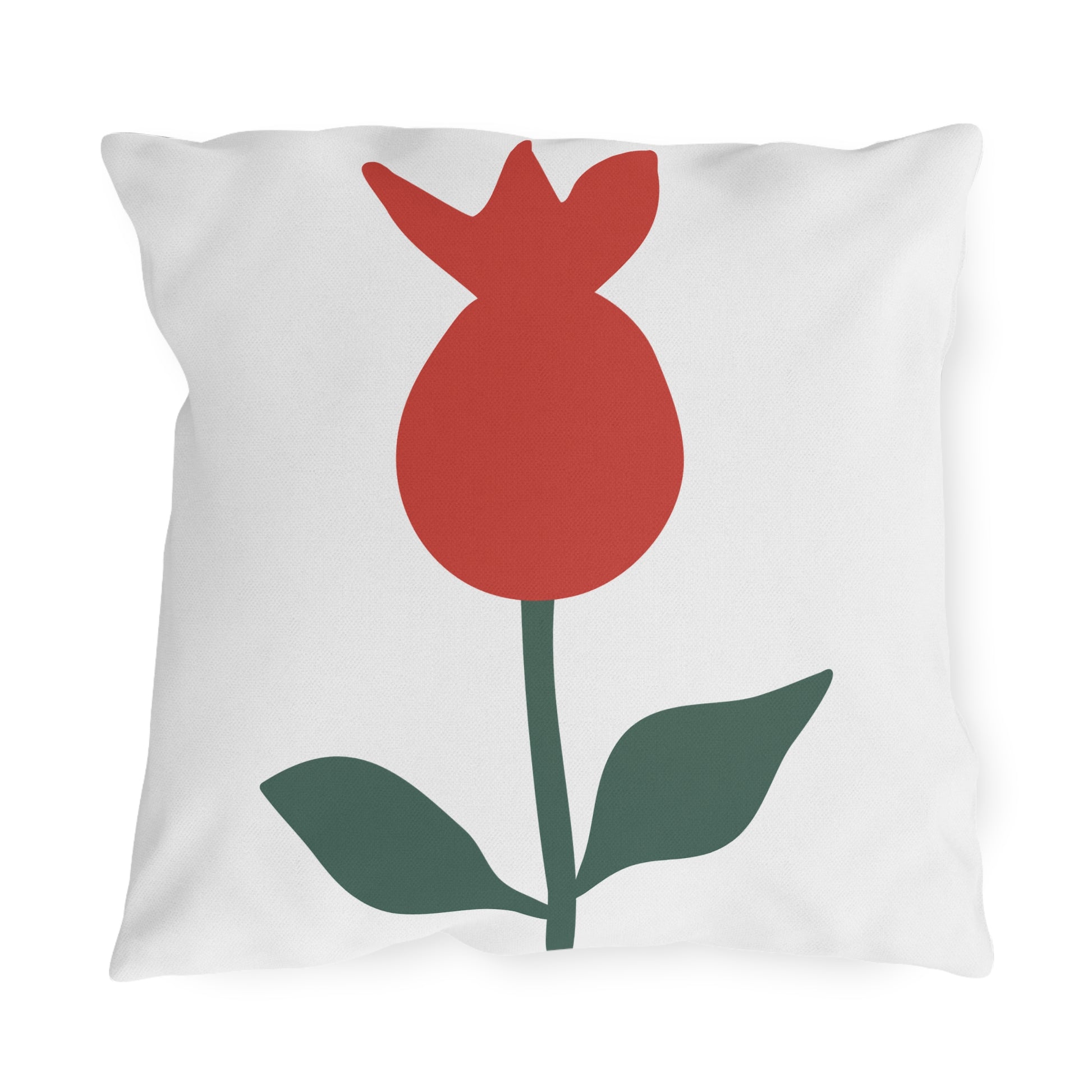White pillow with a red tulip design on a white background