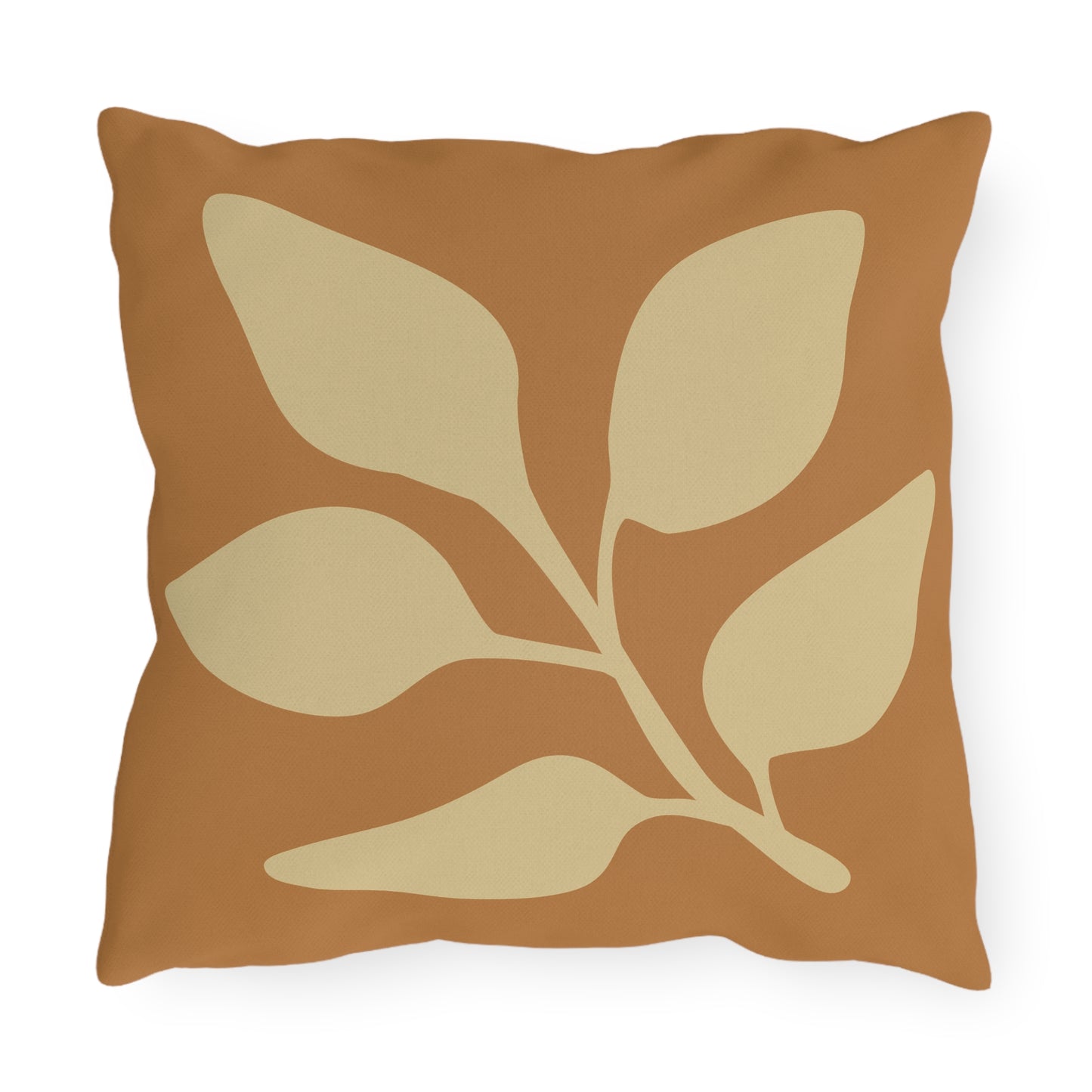 Decorative pillow with leaf pattern on a brown background