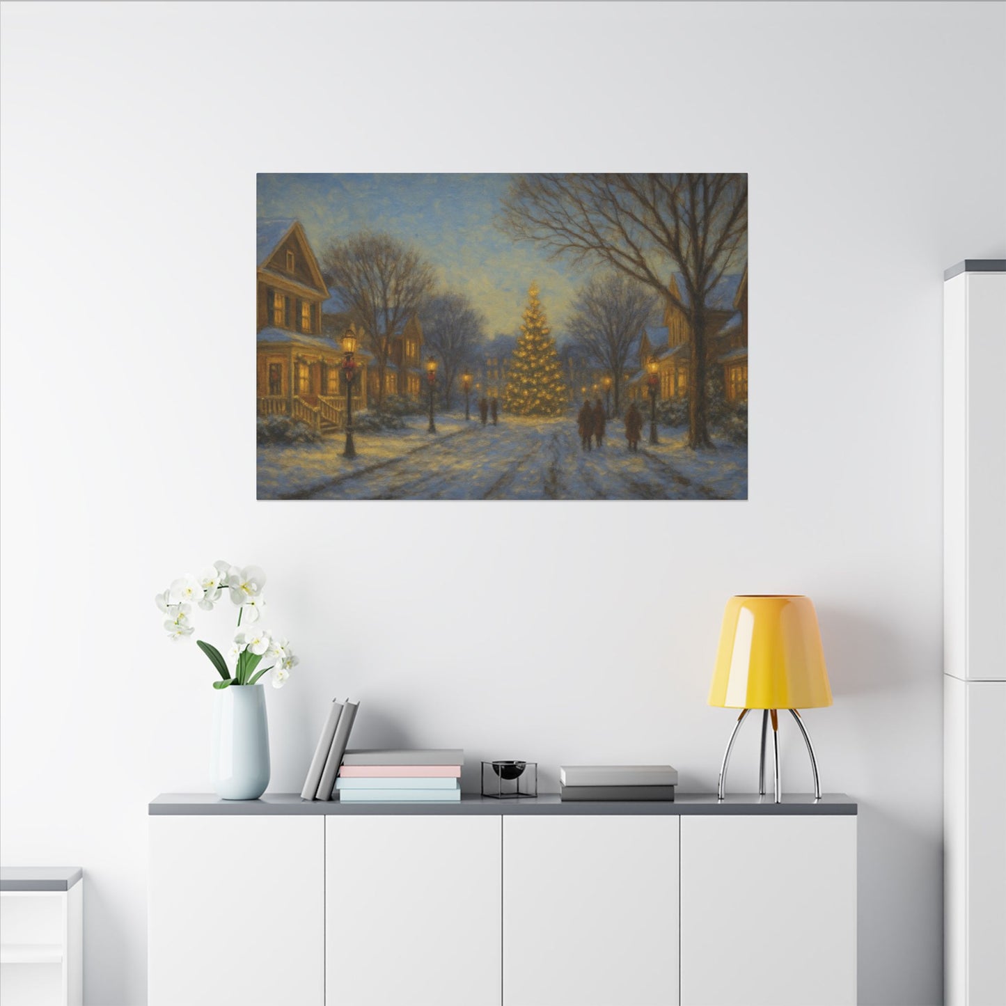 Framed winter scene painting on a wall above a white cabinet with decorative items.