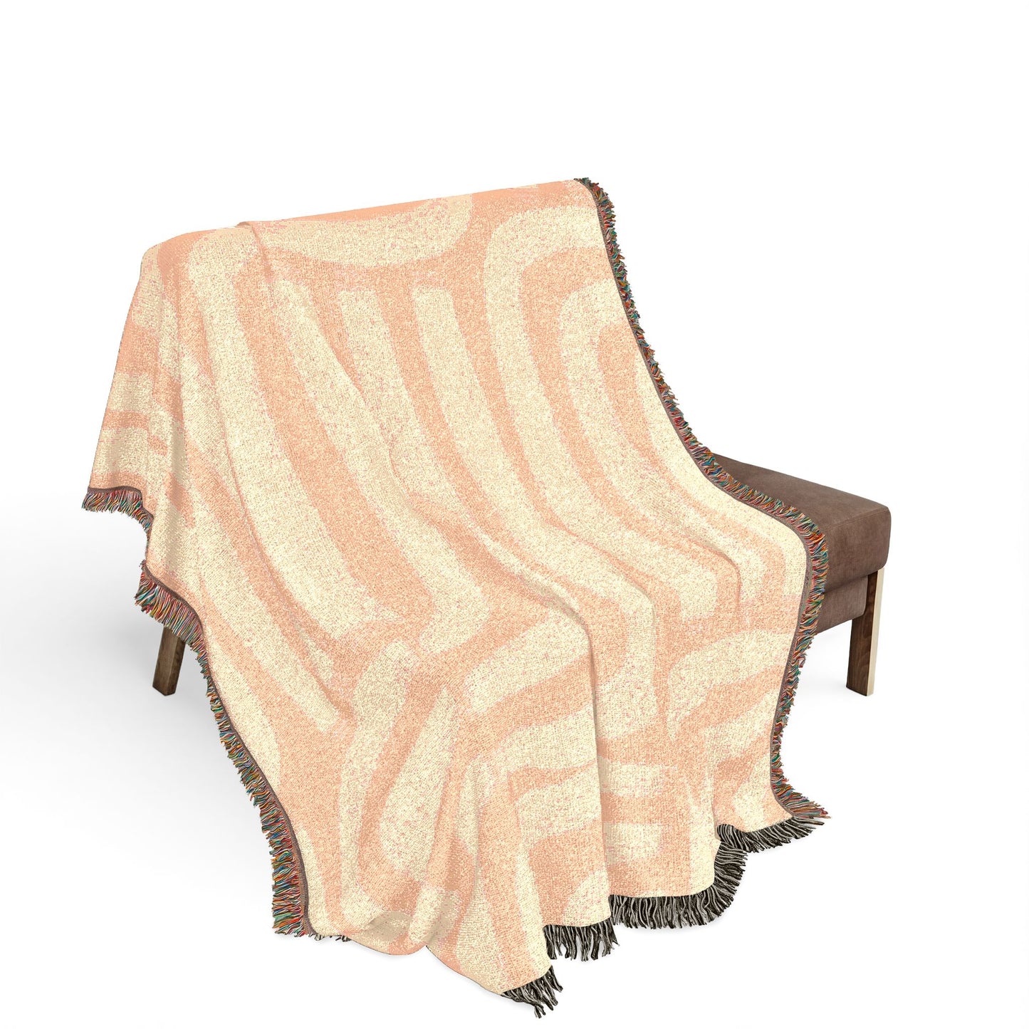 Woven blanket with wavy pattern draped over a chair on a white background