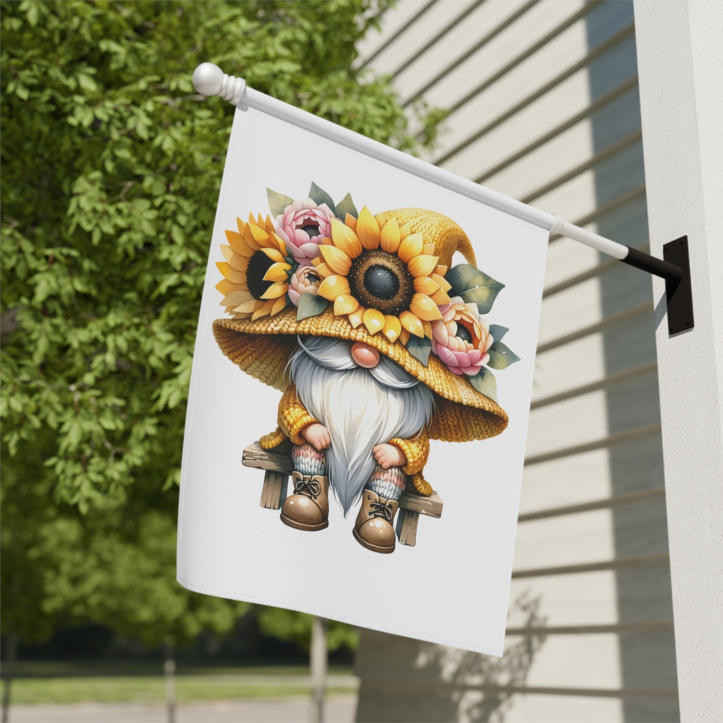Decorative flag with a gnome wearing a sunflower hat on a house exterior.