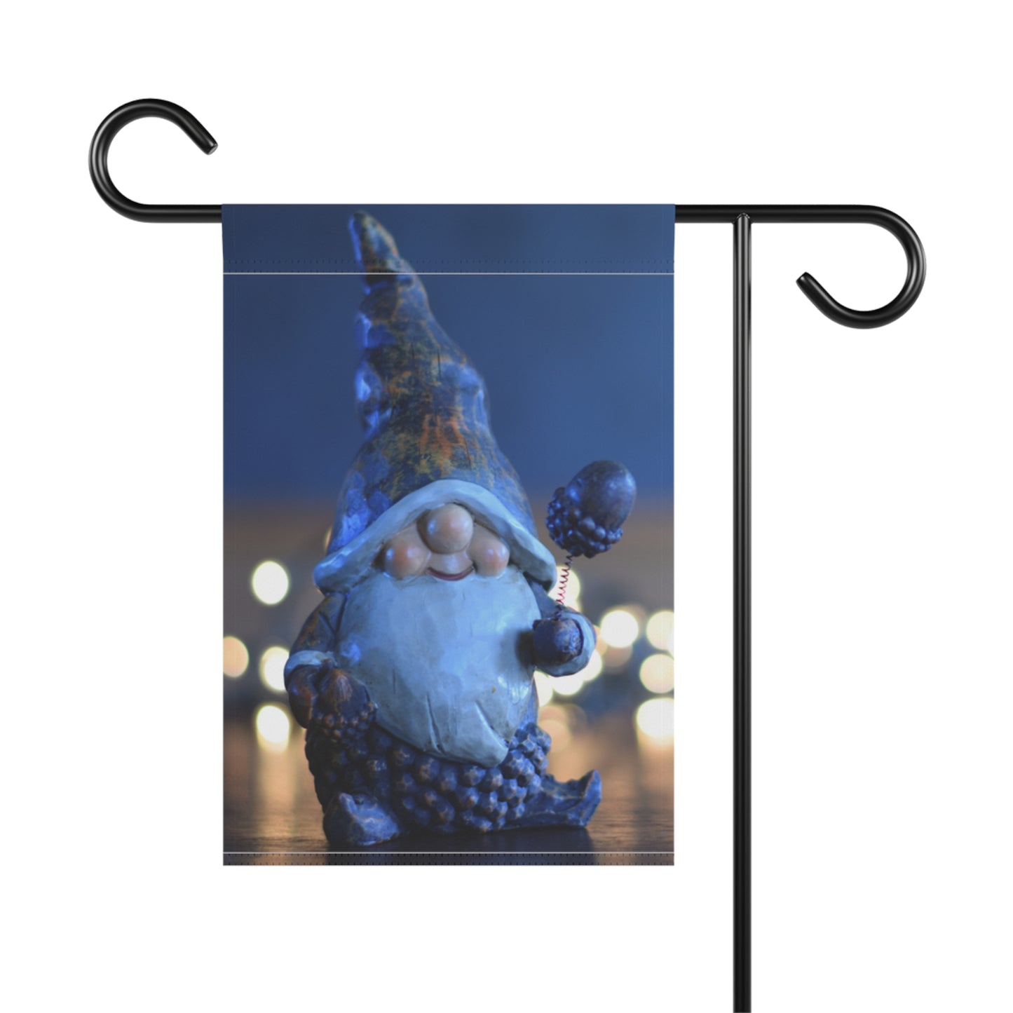 Garden flag with a blue gnome design on a blurred night background