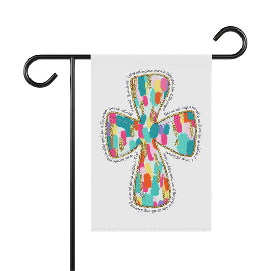 Decorative garden flag with colorful cross design on a white background