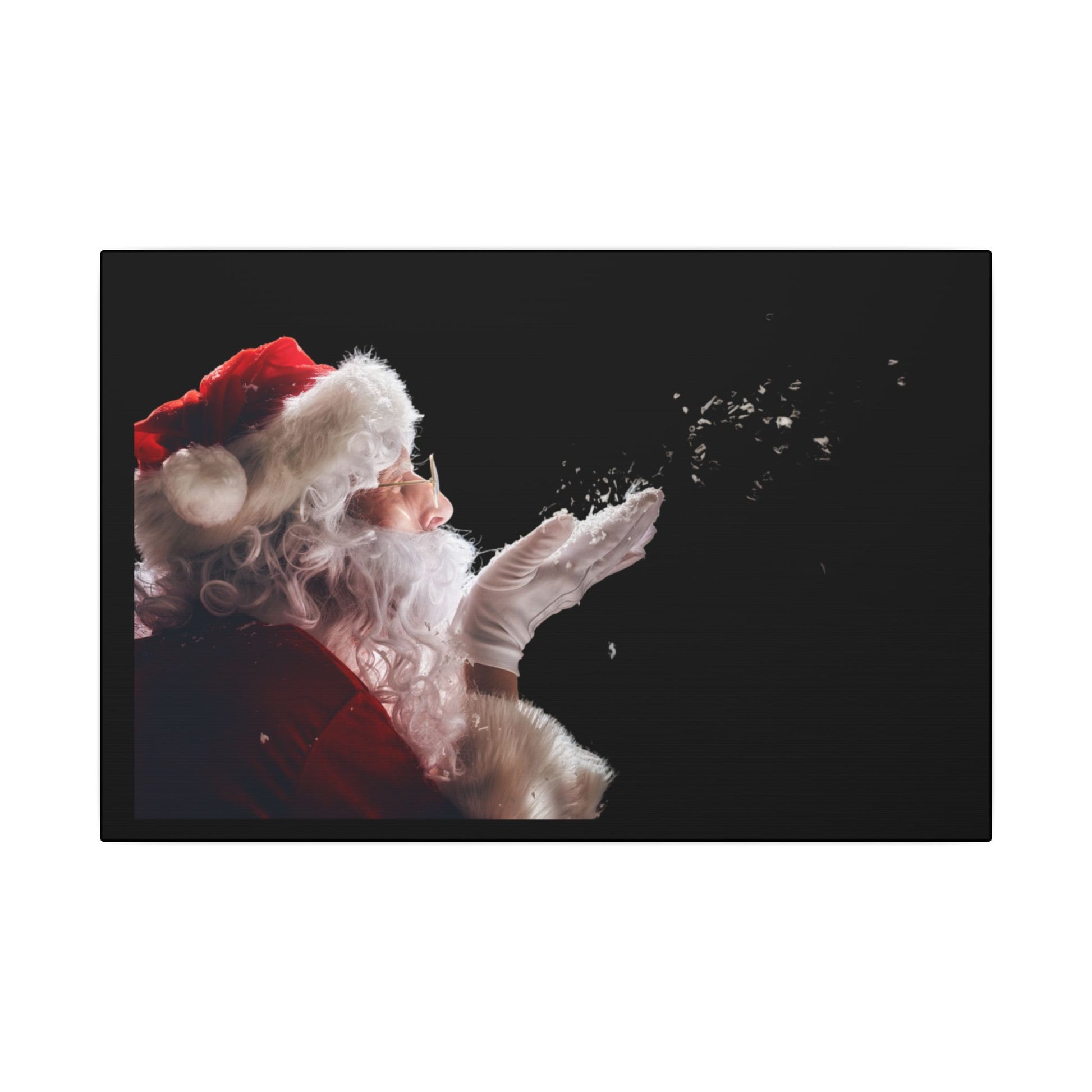 Santa Claus blowing snowflakes against a black background