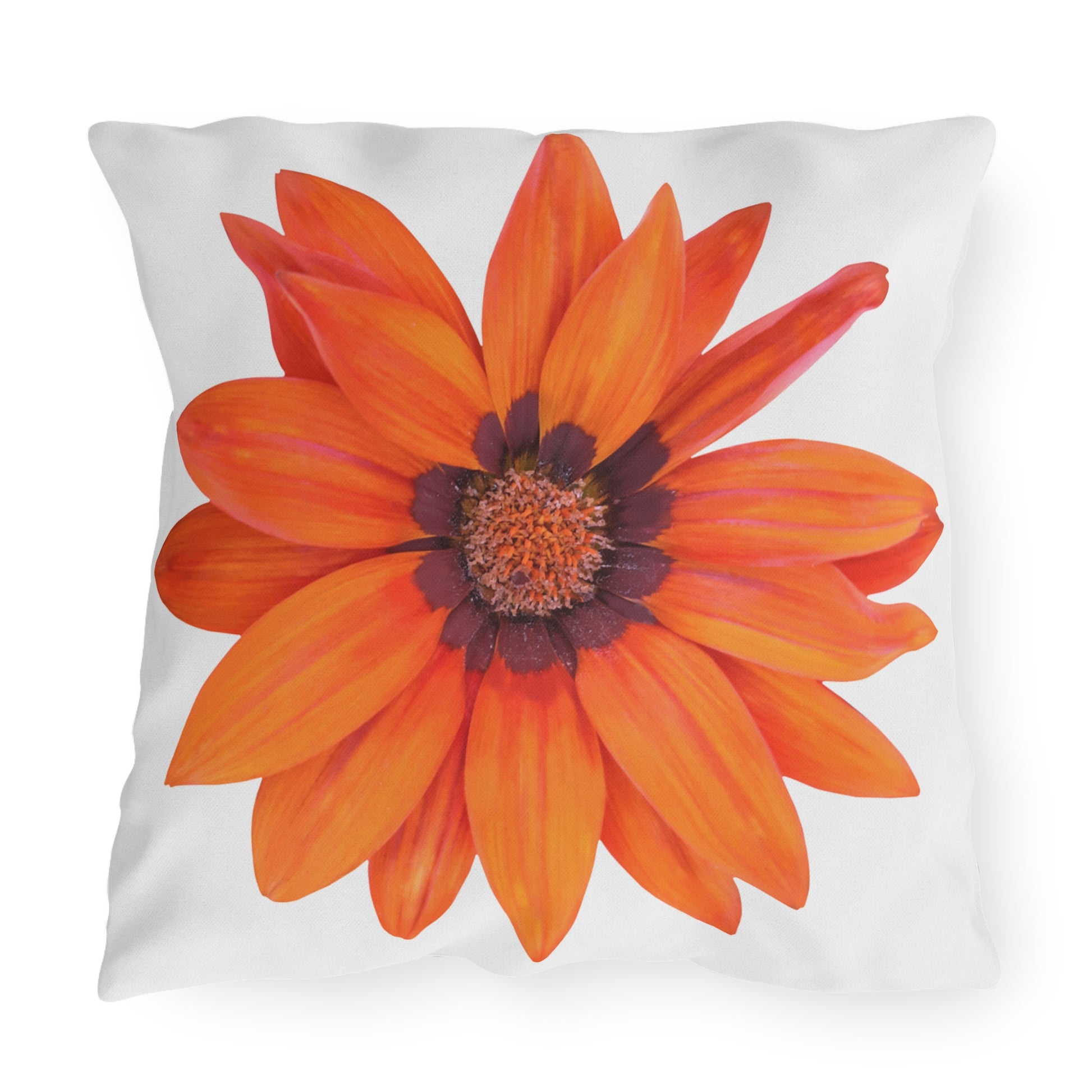 Pillow with a large orange flower design on a white background