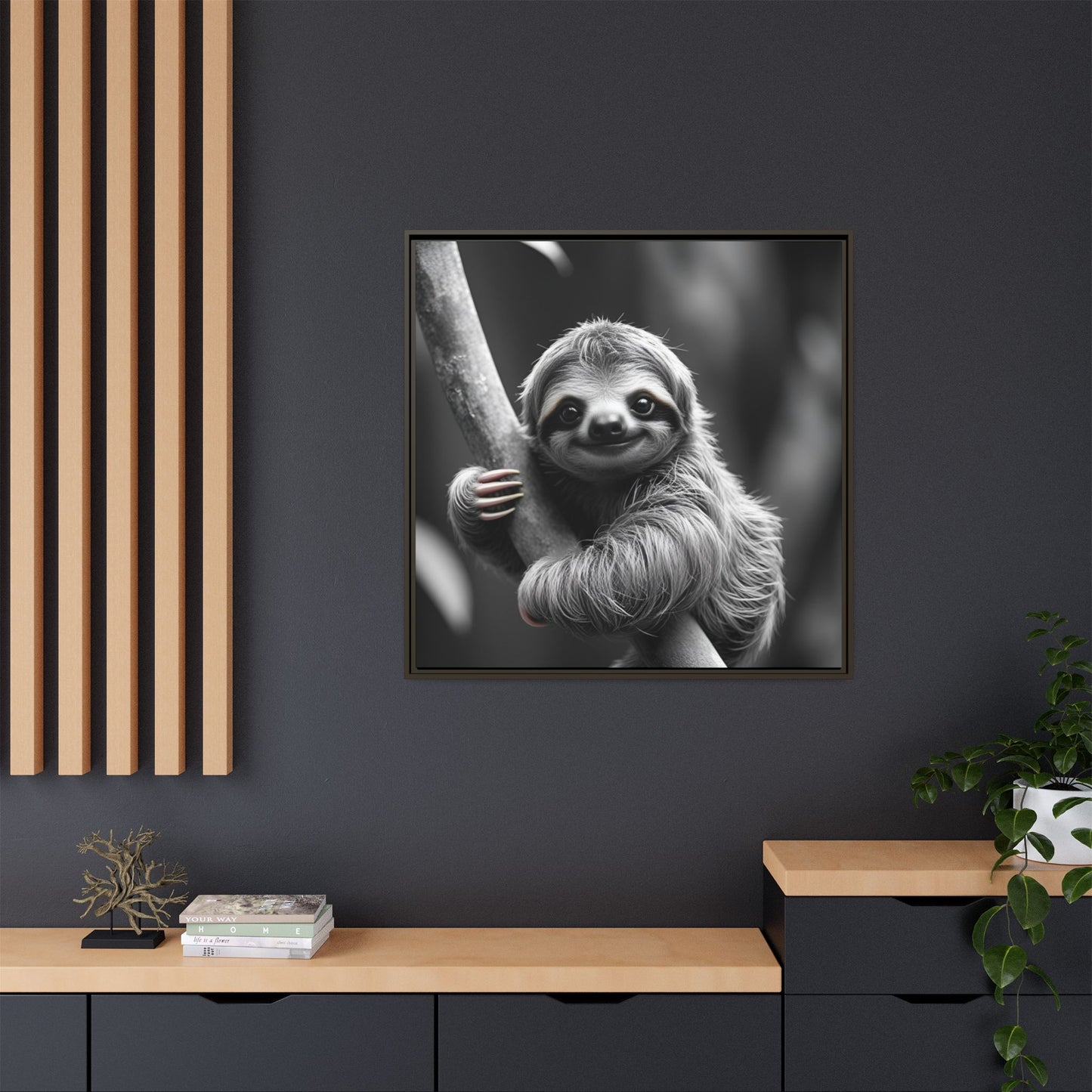 Framed black and white photo of a sloth on a dark wall with wooden shelves.