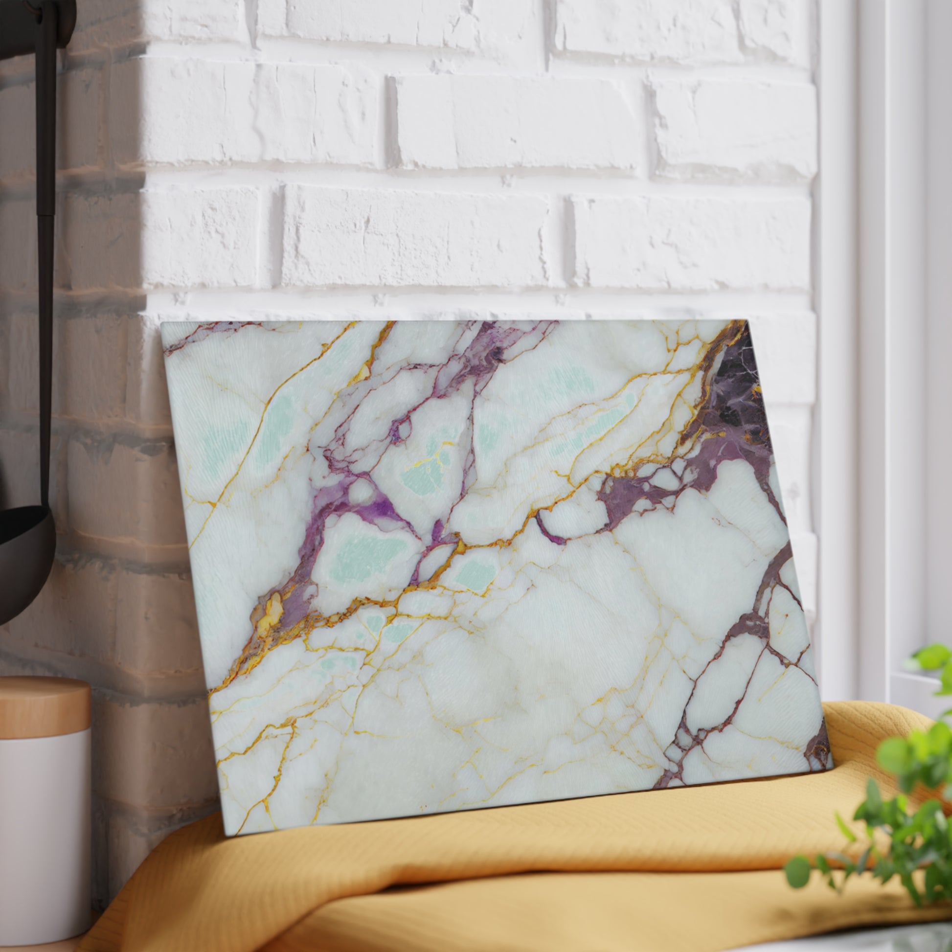 Marble-patterned laptop on a yellow surface with a white brick wall background