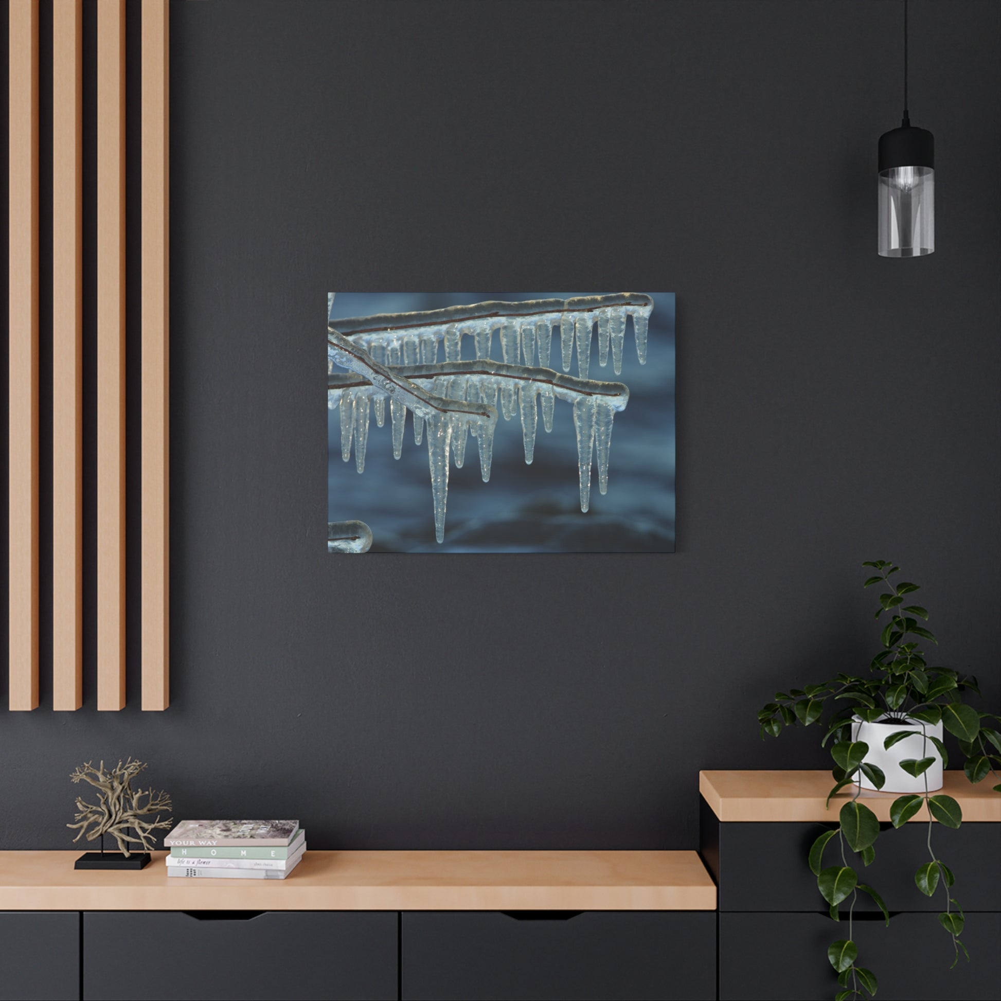 Framed artwork of icicles on a dark wall with wooden shelves and decor.