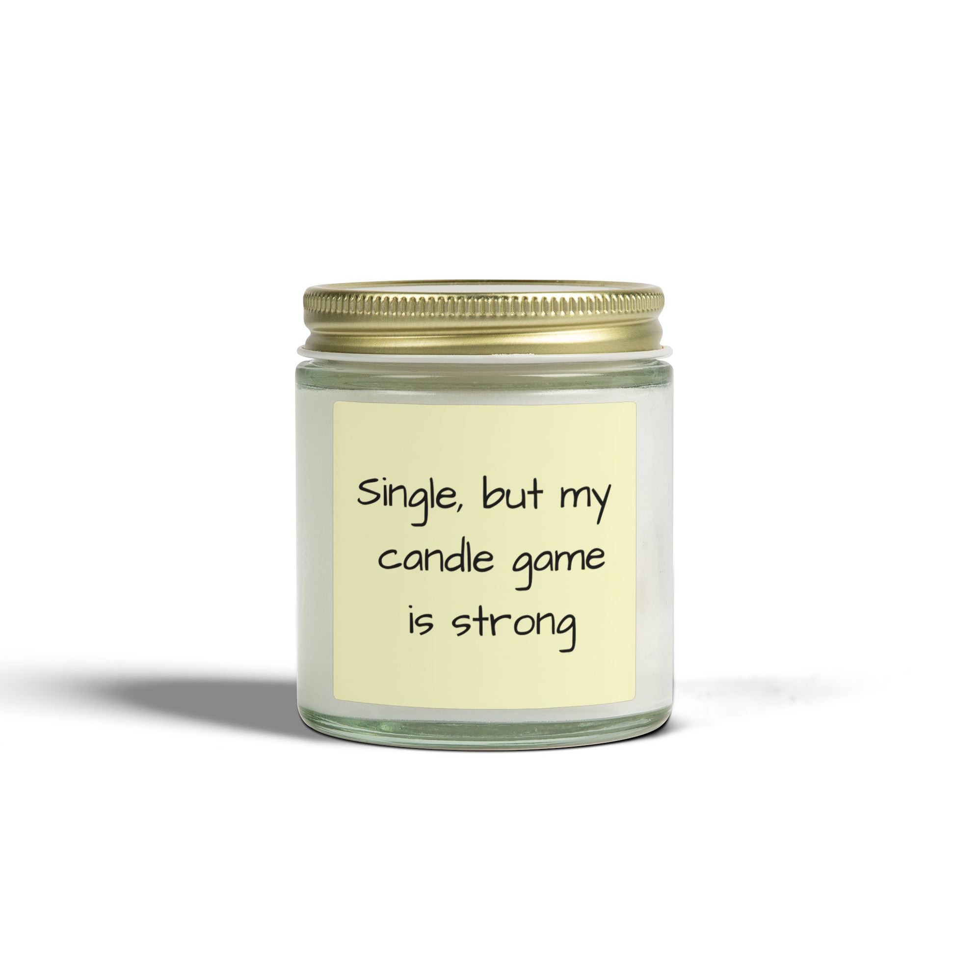 Candle in a glass jar with a gold lid and a humorous label on a white background