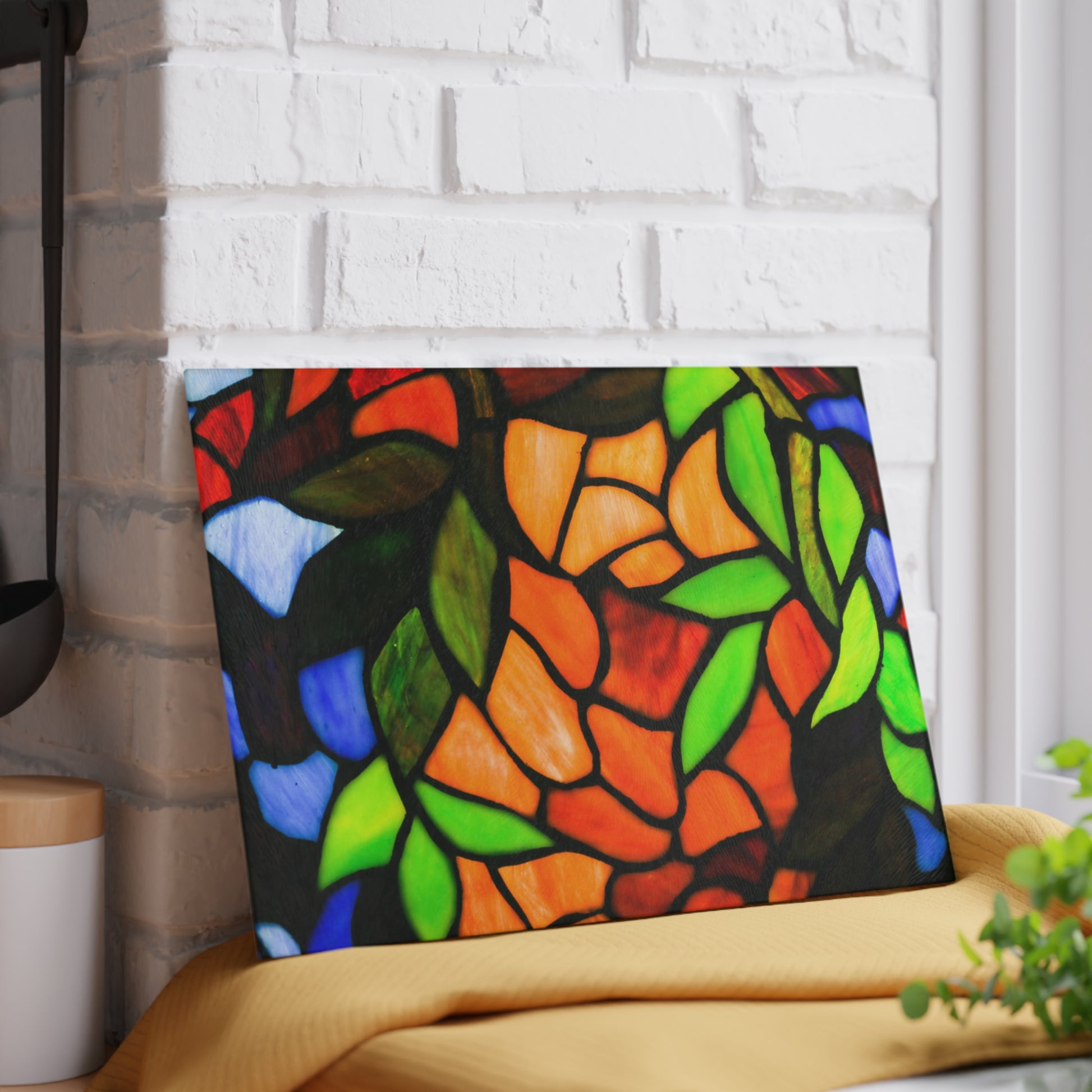 Colorful stained glass art piece on a white brick wall background