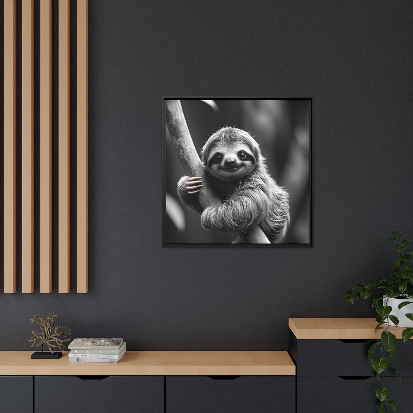 Framed black and white photo of a sloth on a dark wall with wooden shelves.