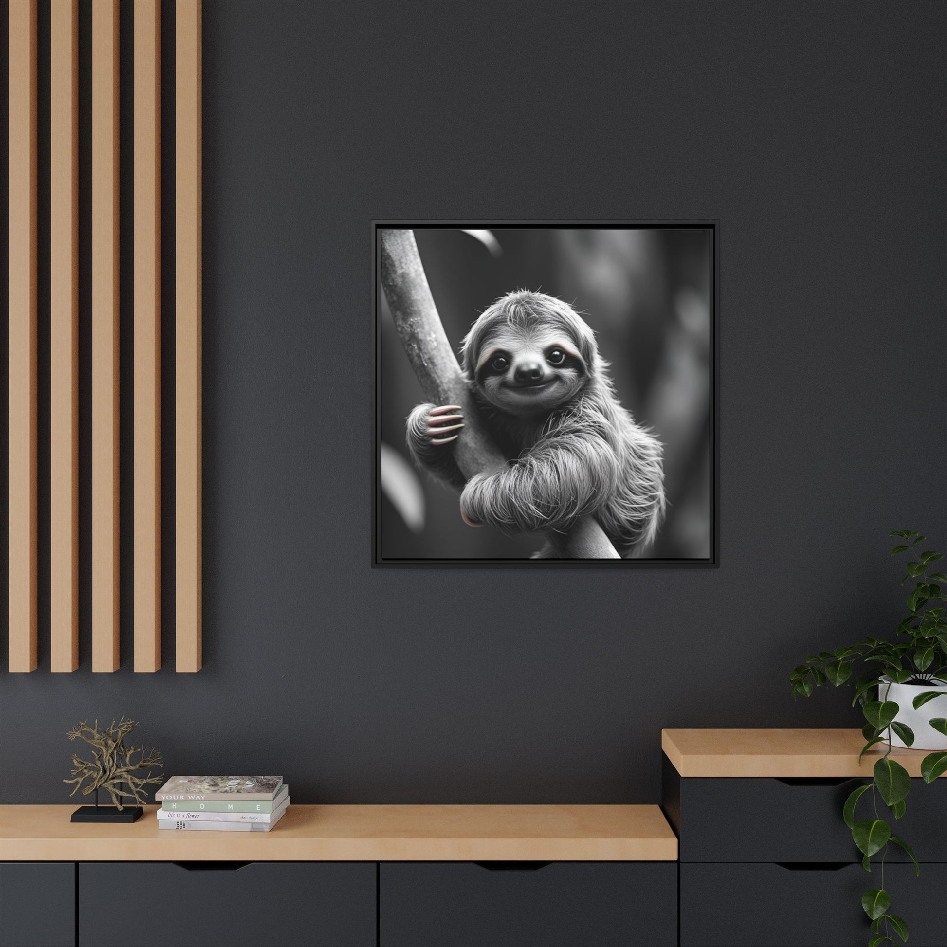 Framed black and white photo of a sloth on a dark wall with wooden shelves.