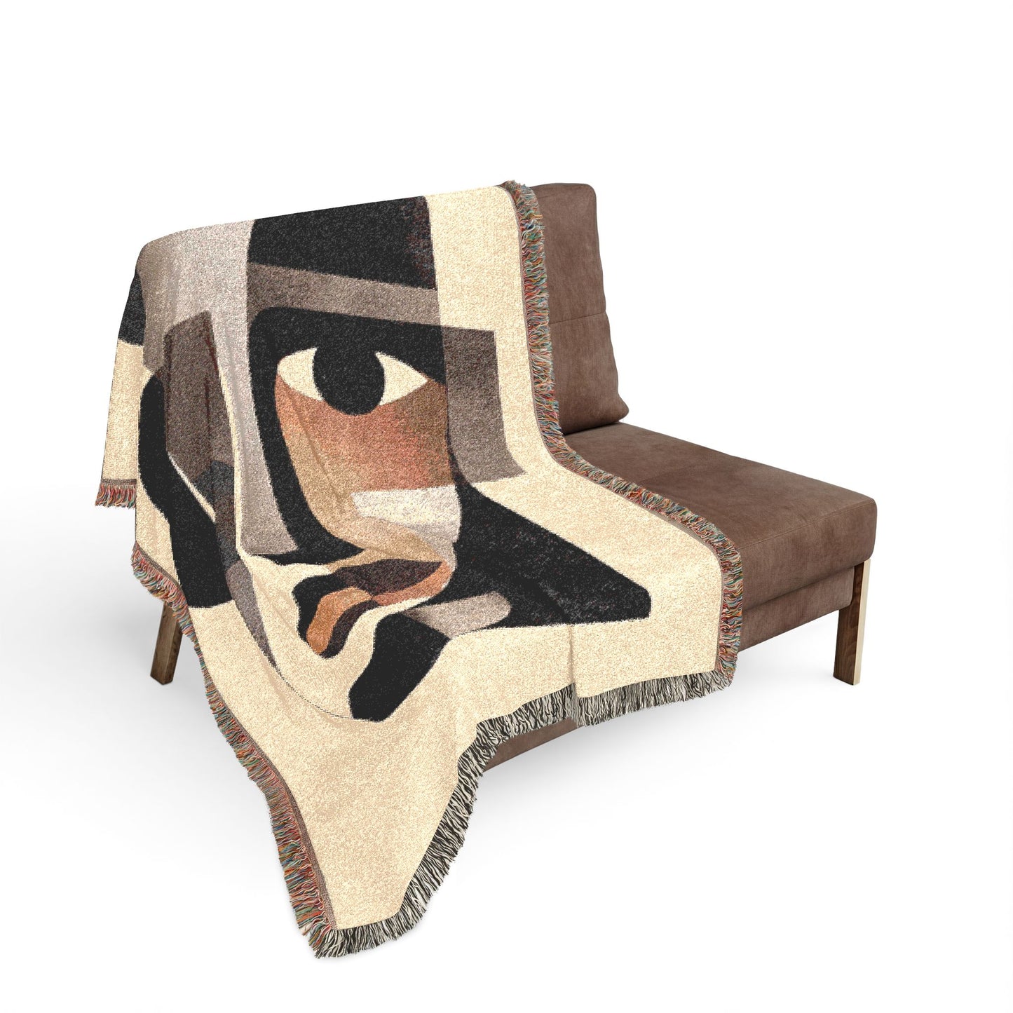 Abstract patterned blanket draped over a brown chair on a white background