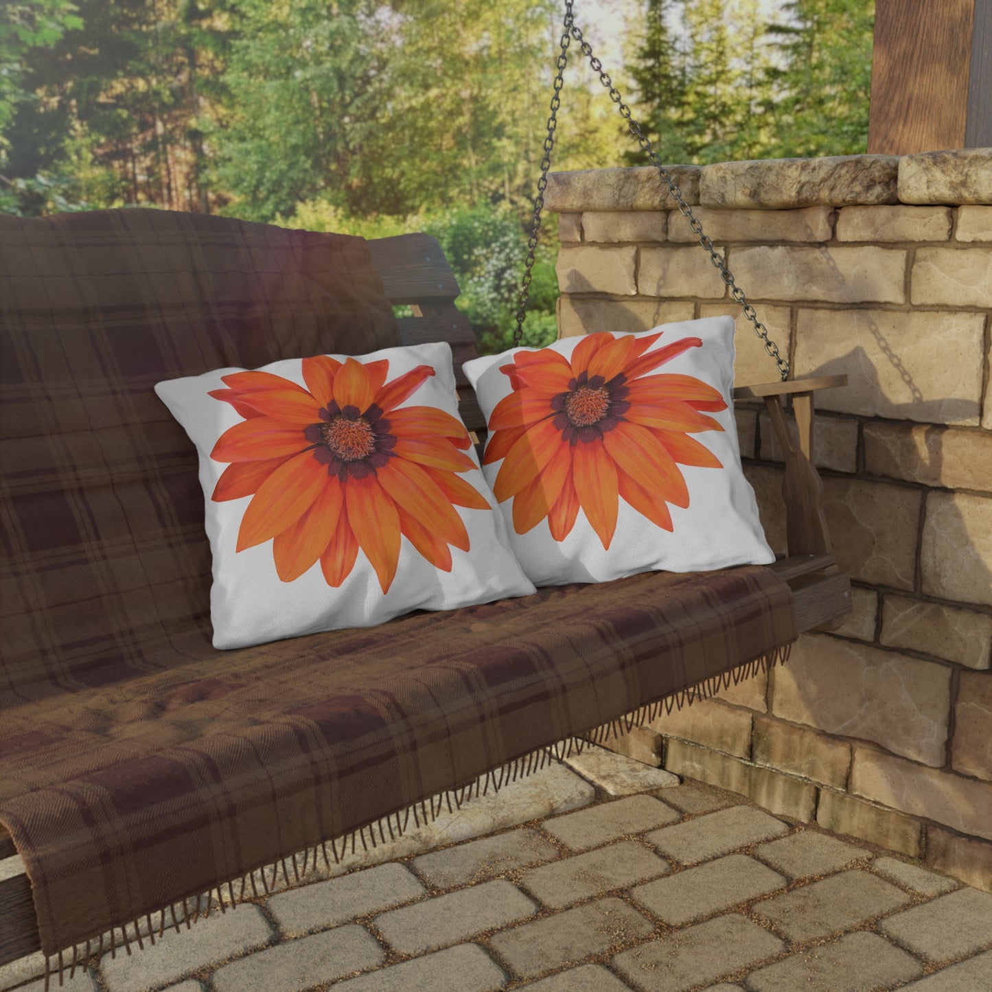 Wooden swing with floral cushions on a stone patio