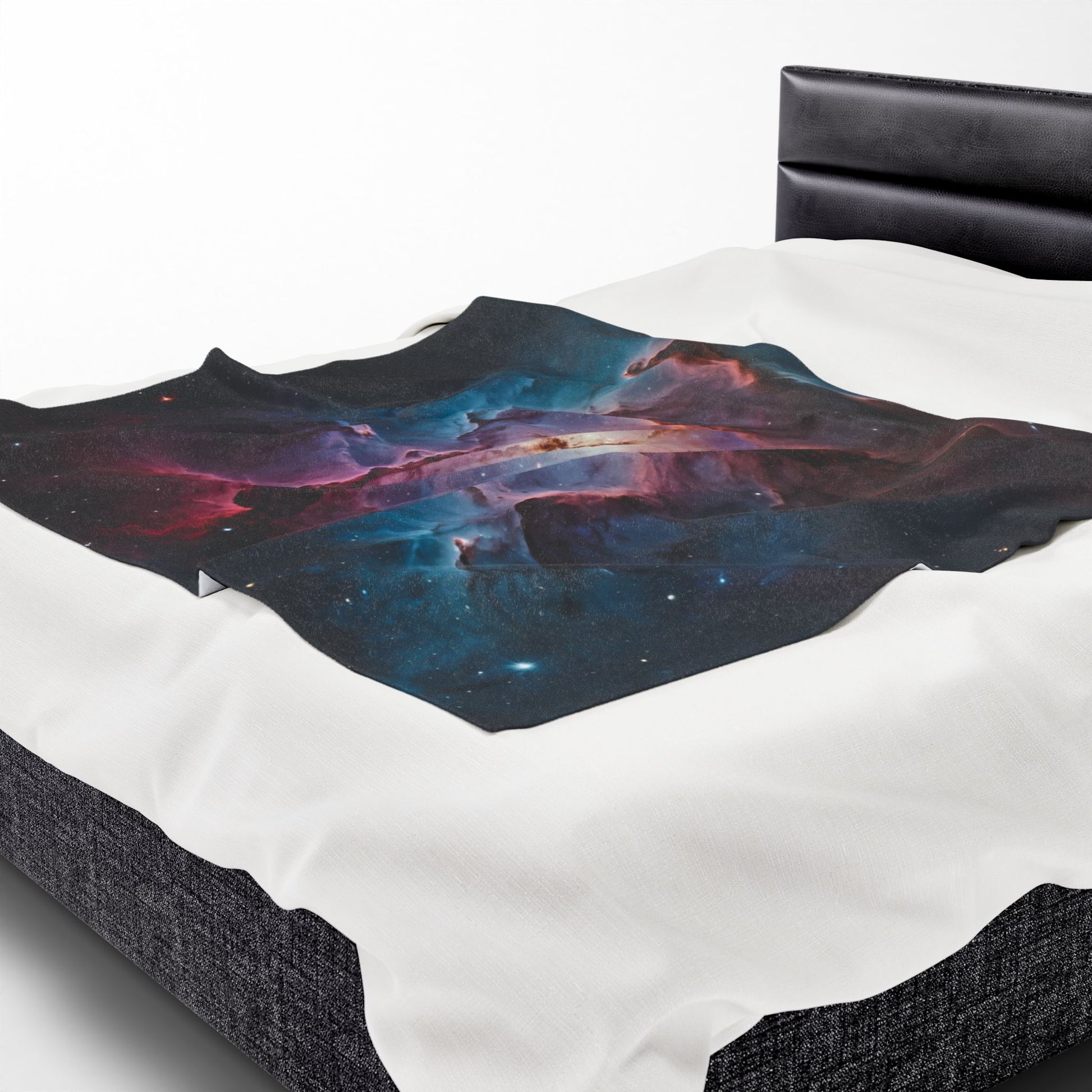 Bedding set with a space-themed design on a bed