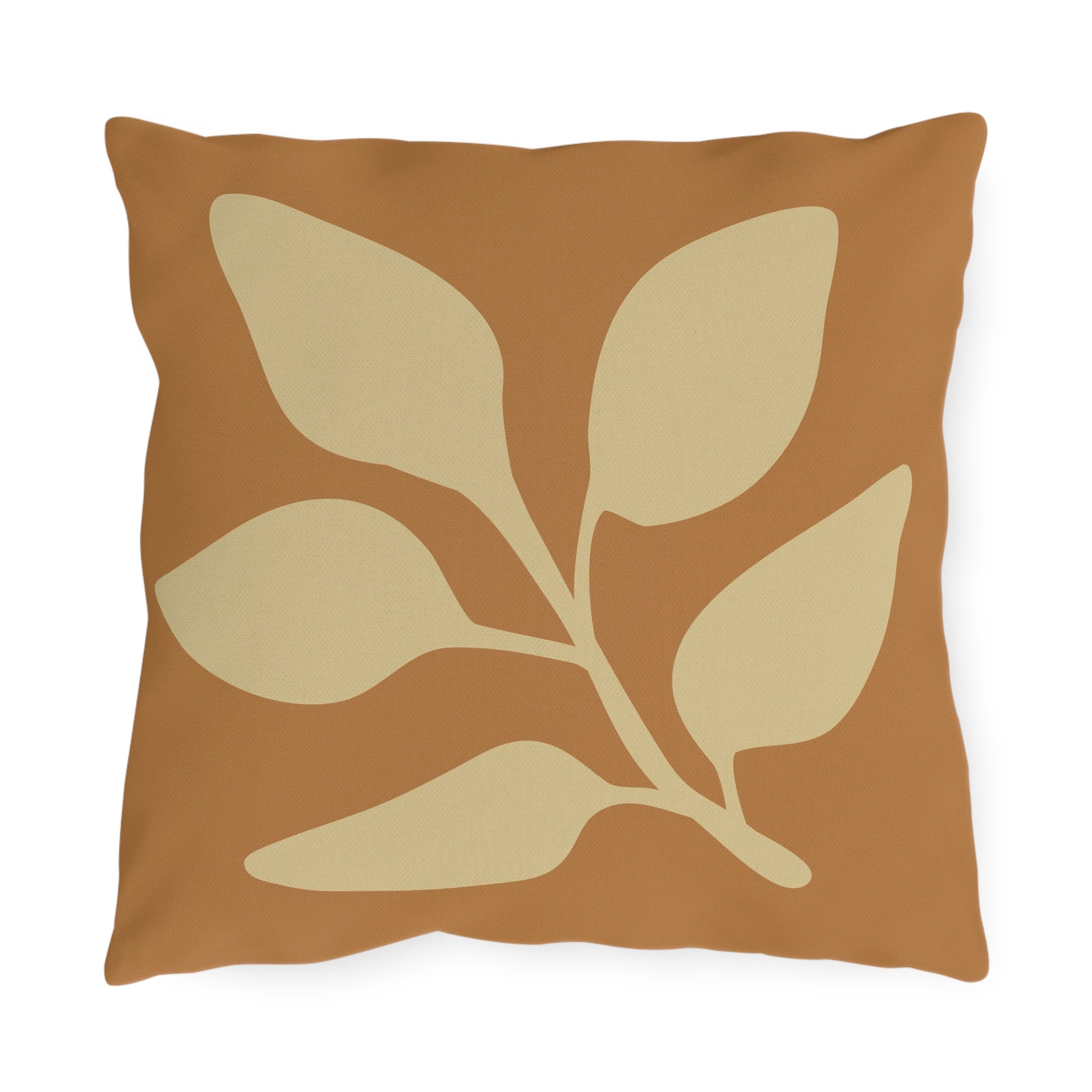 Decorative pillow with beige leaf pattern on a brown background